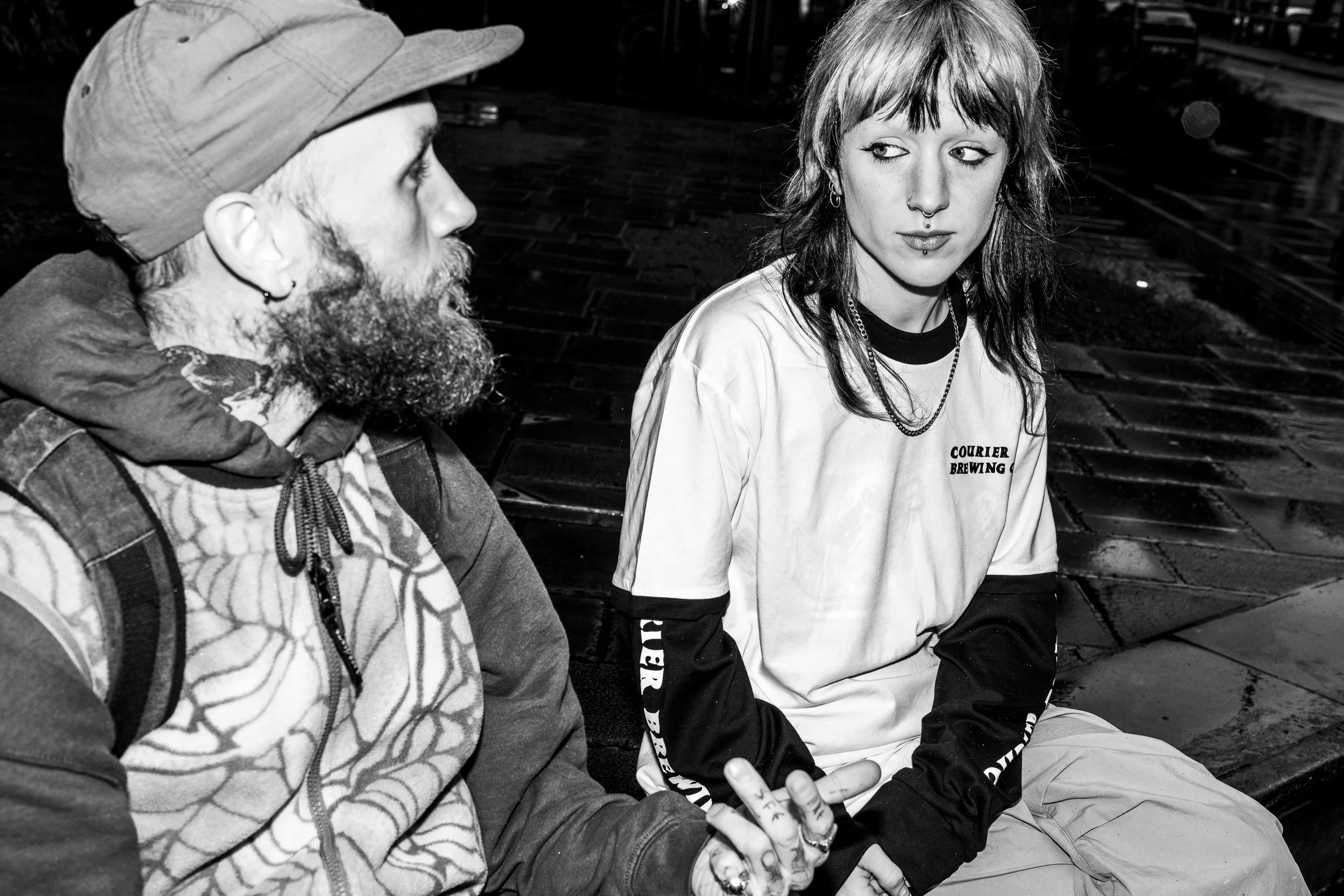 Alice, a skateboarder, wearing a layered long and short sleeve Courier Brewing Co t-shirt for a merch shoot in Manchester, UK