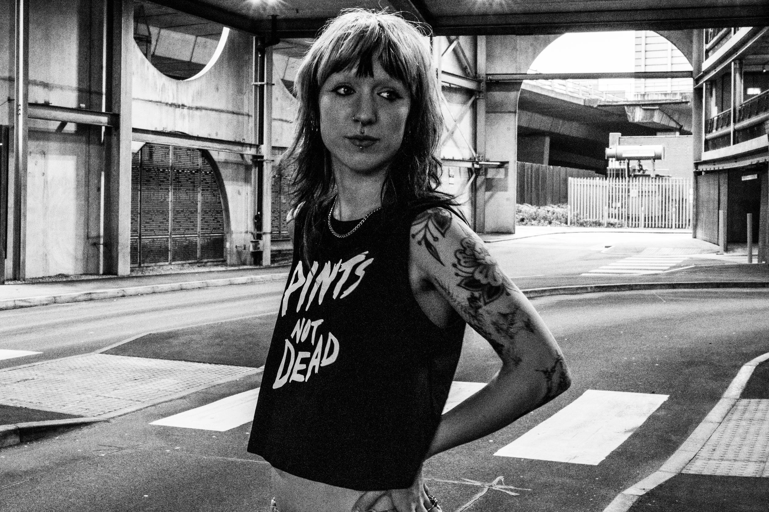 Skateboarder Alice wearing Courier Brewing Co. "Pint Not Dead" tank top