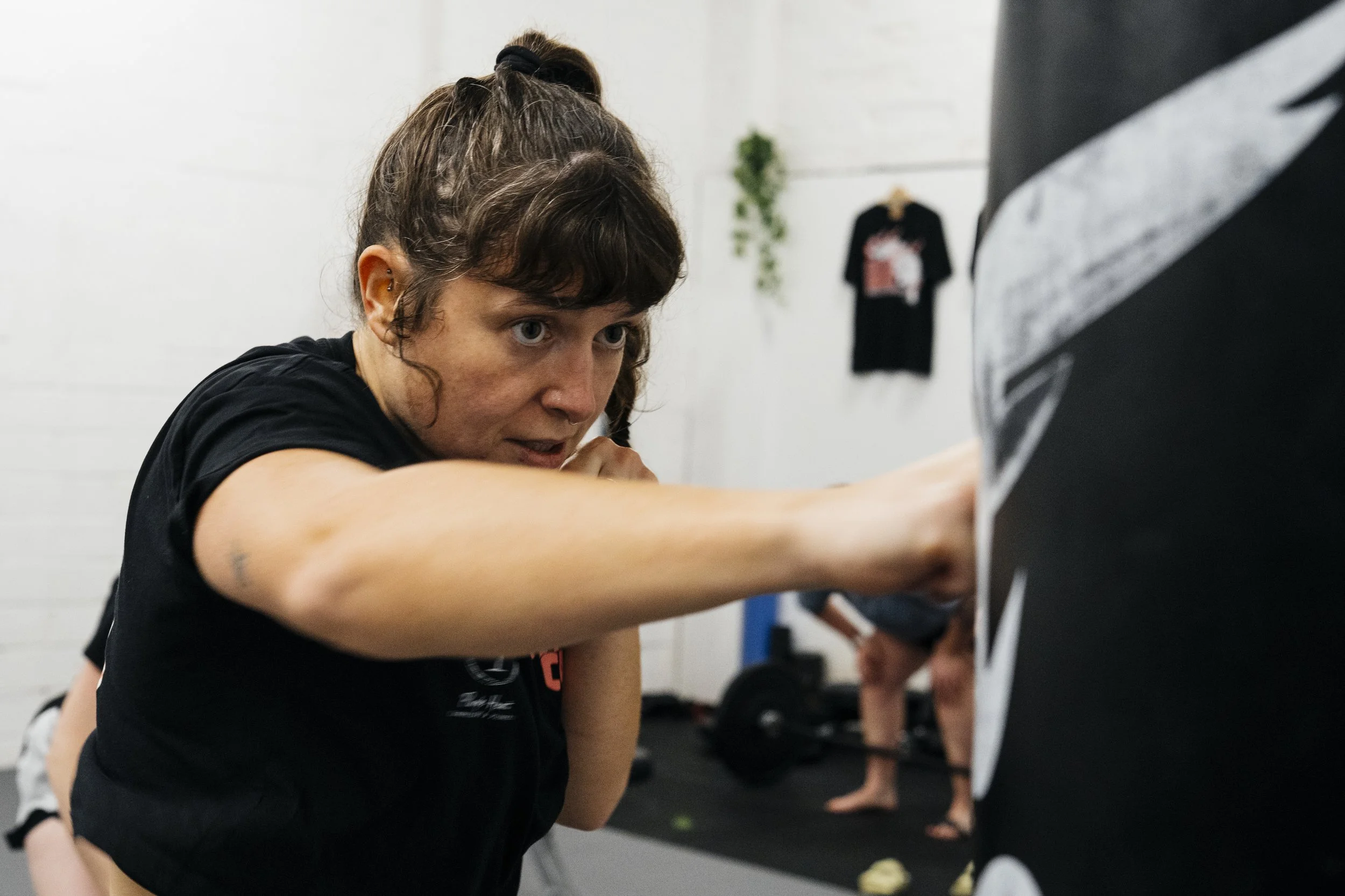 Fighter punching a punch bag at Athena Combat Club Fighter's Class at Cool Heart Muay Thai Studios, Bristol