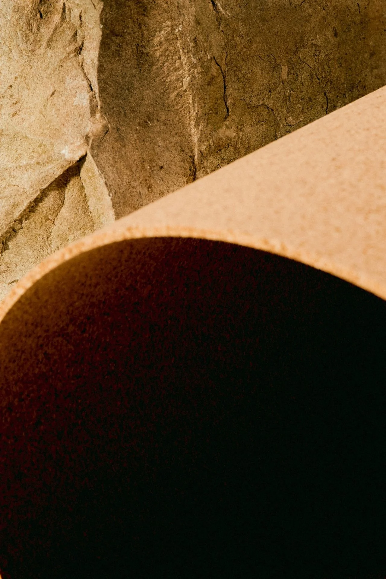 close up of a clay tunnel against a rocky cliff