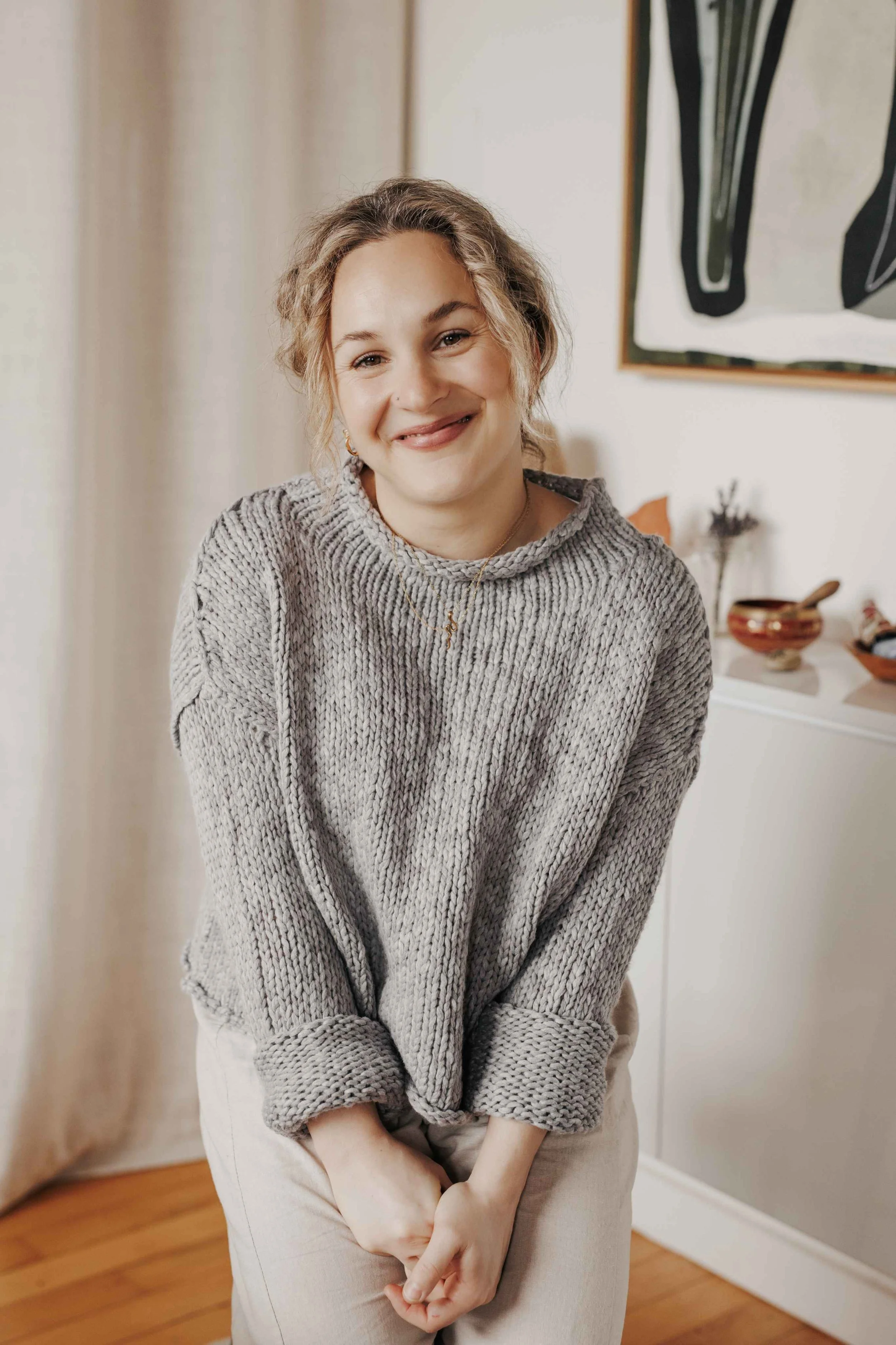 headshot of kaitlin lane smiling at the camera in her corktown rmt studio-bordered