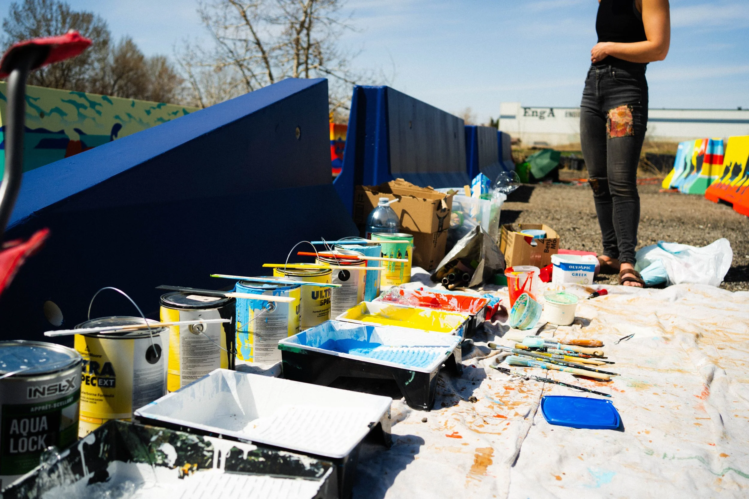 Paint supplies beside jersey barriers being painted for BUMP Road Works