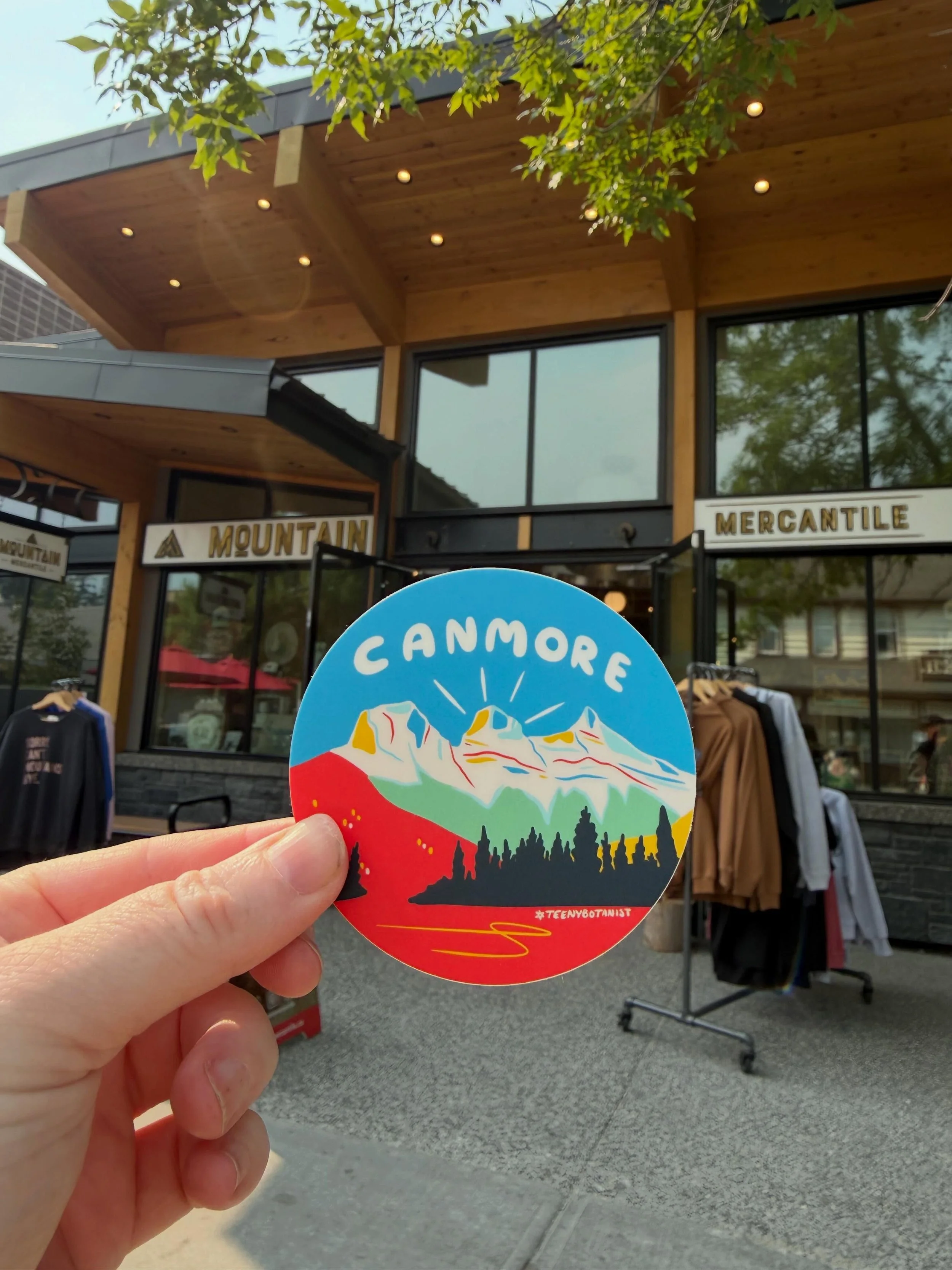 A little piece of Canmore, available right here at @mountainmercantile on Main Street.

My Canmore sticker is part of a whole series of locally inspired designs, alongside totes, tees, notebooks, and greeting cards. You can find them here at Mountain