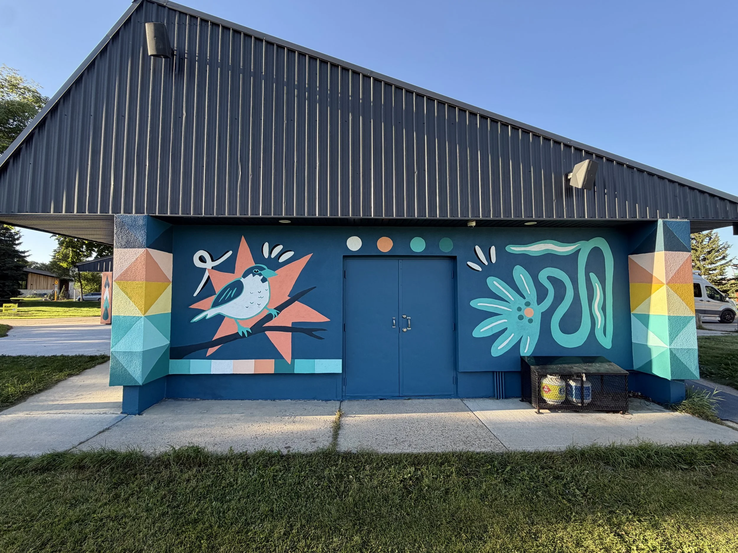Rear wall of the Aspen Gardens building with murals