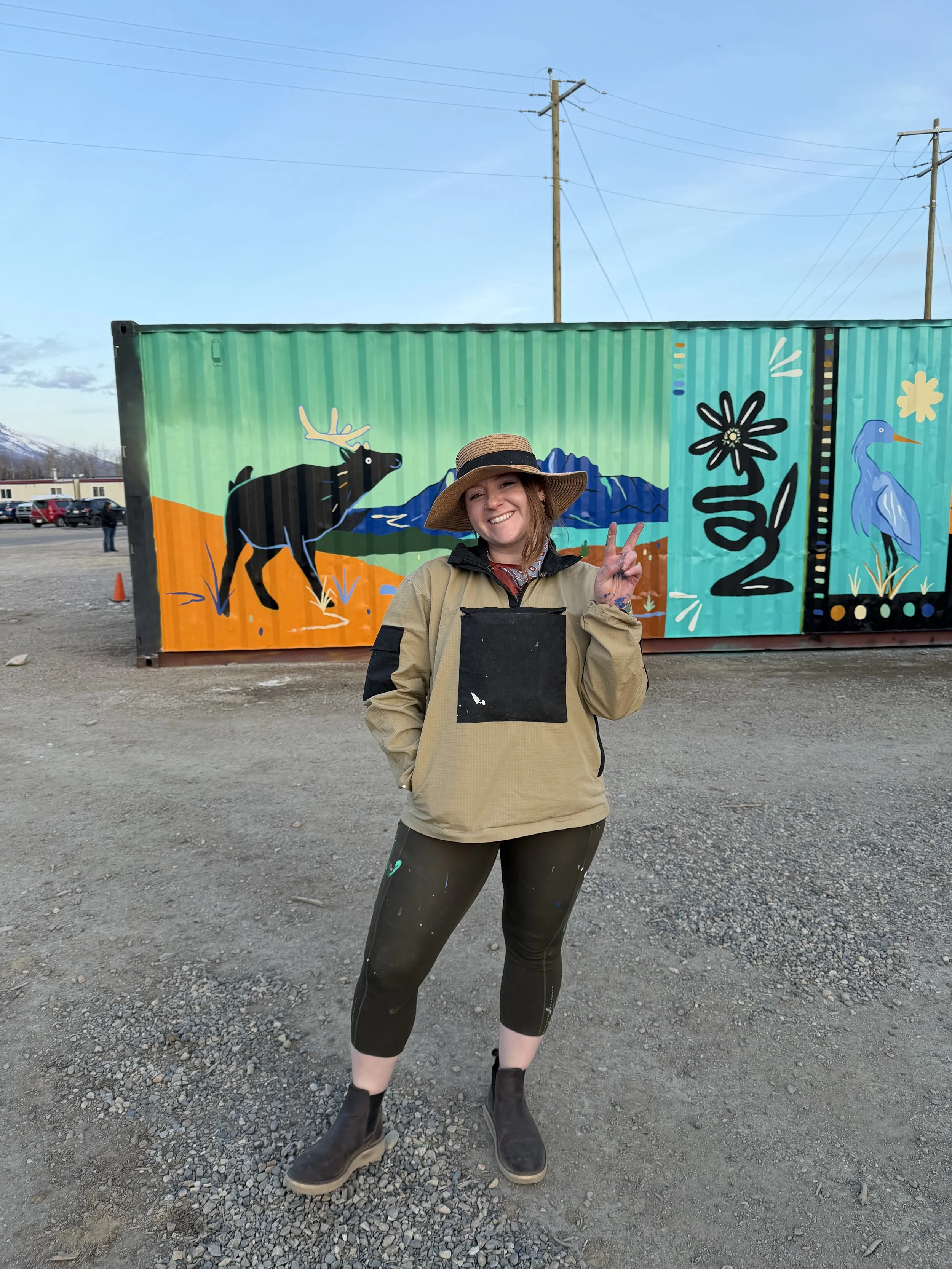 Teenybotanist beside the finished sea can mural at Marmot Meadows
