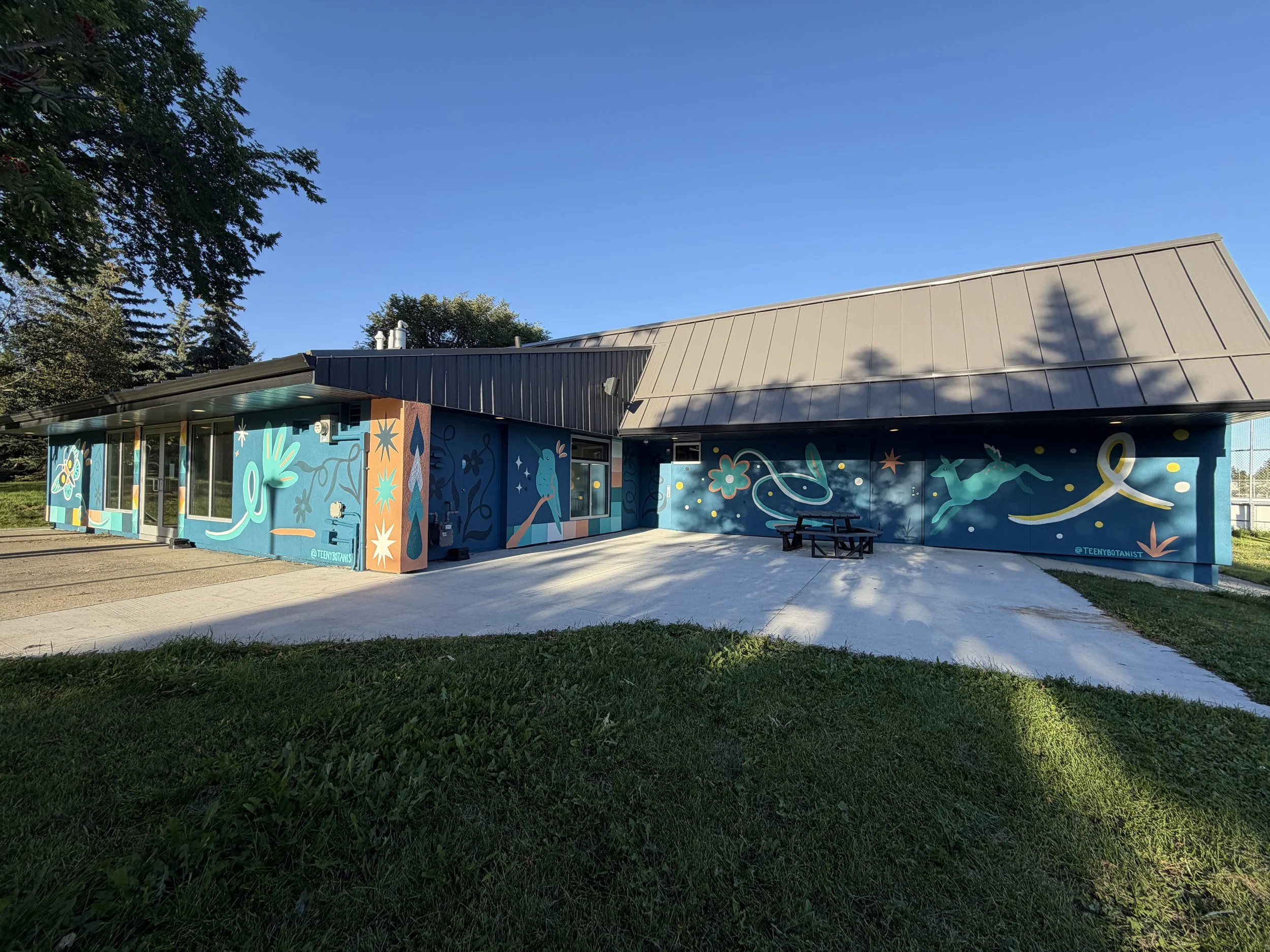 Front of the Aspen Gardens building with Teenybotanist murals