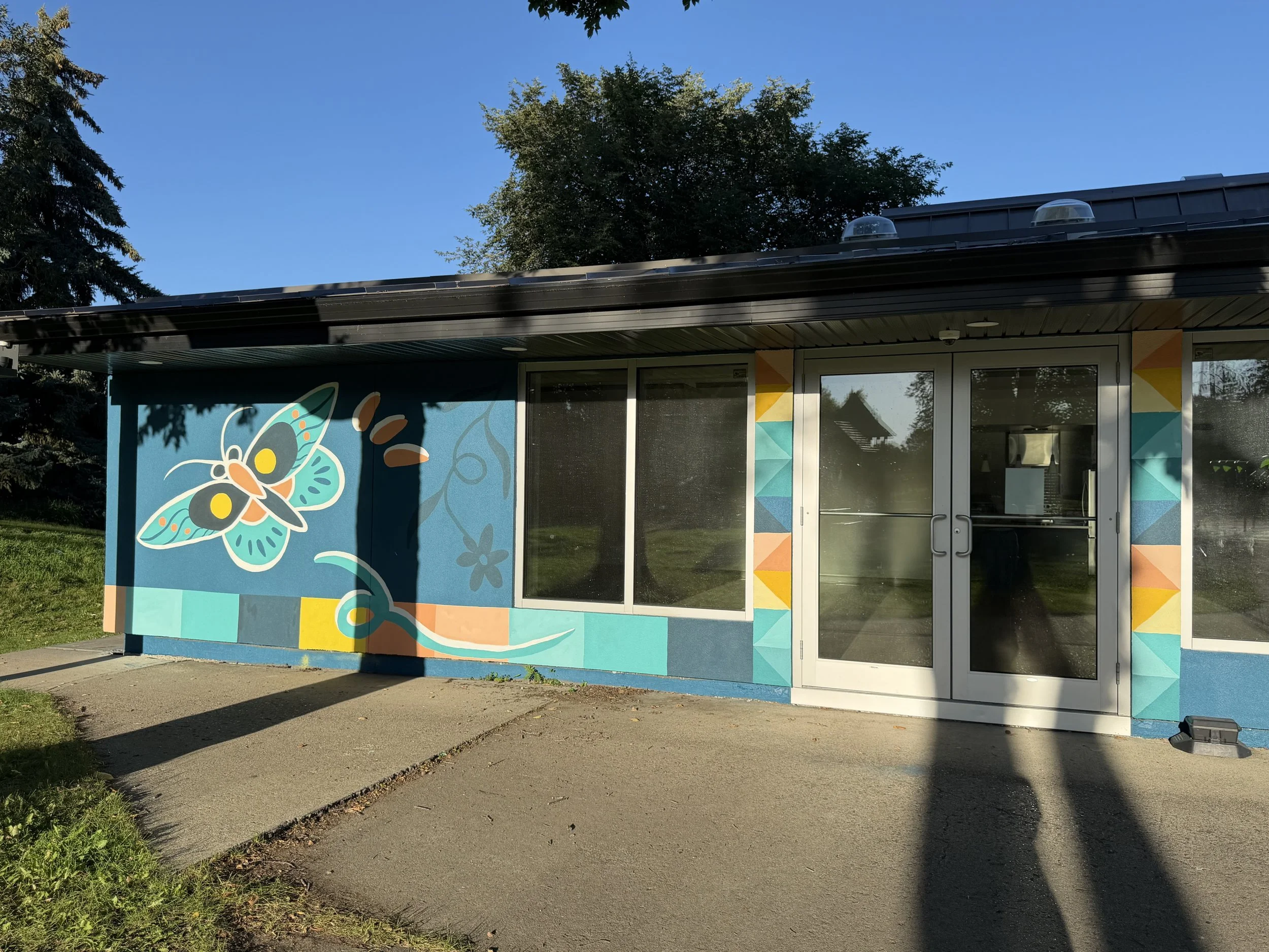 Aspen Gardens murals seen from across the lawn