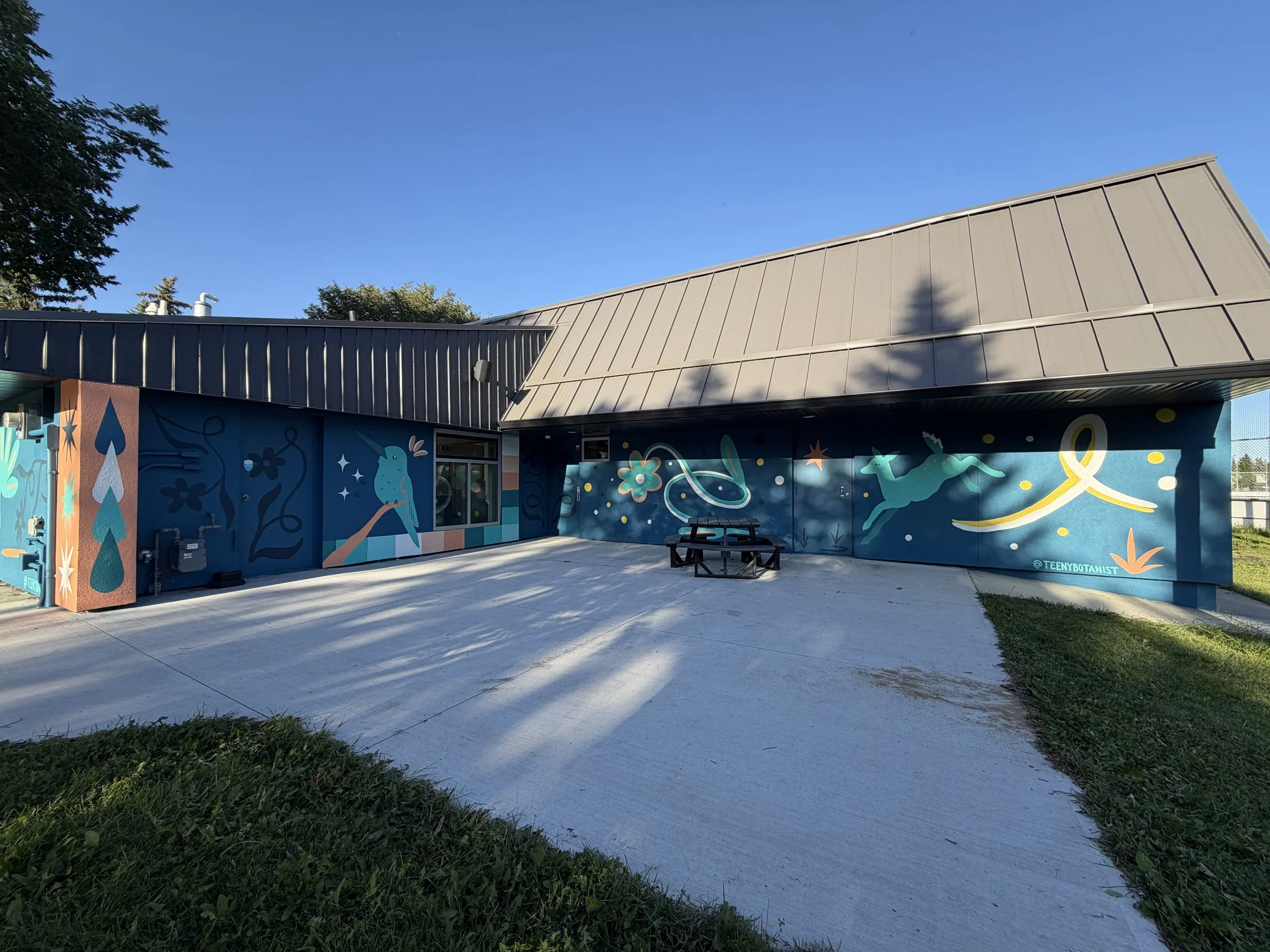 Aspen Gardens Community League building wrapped in colourful murals