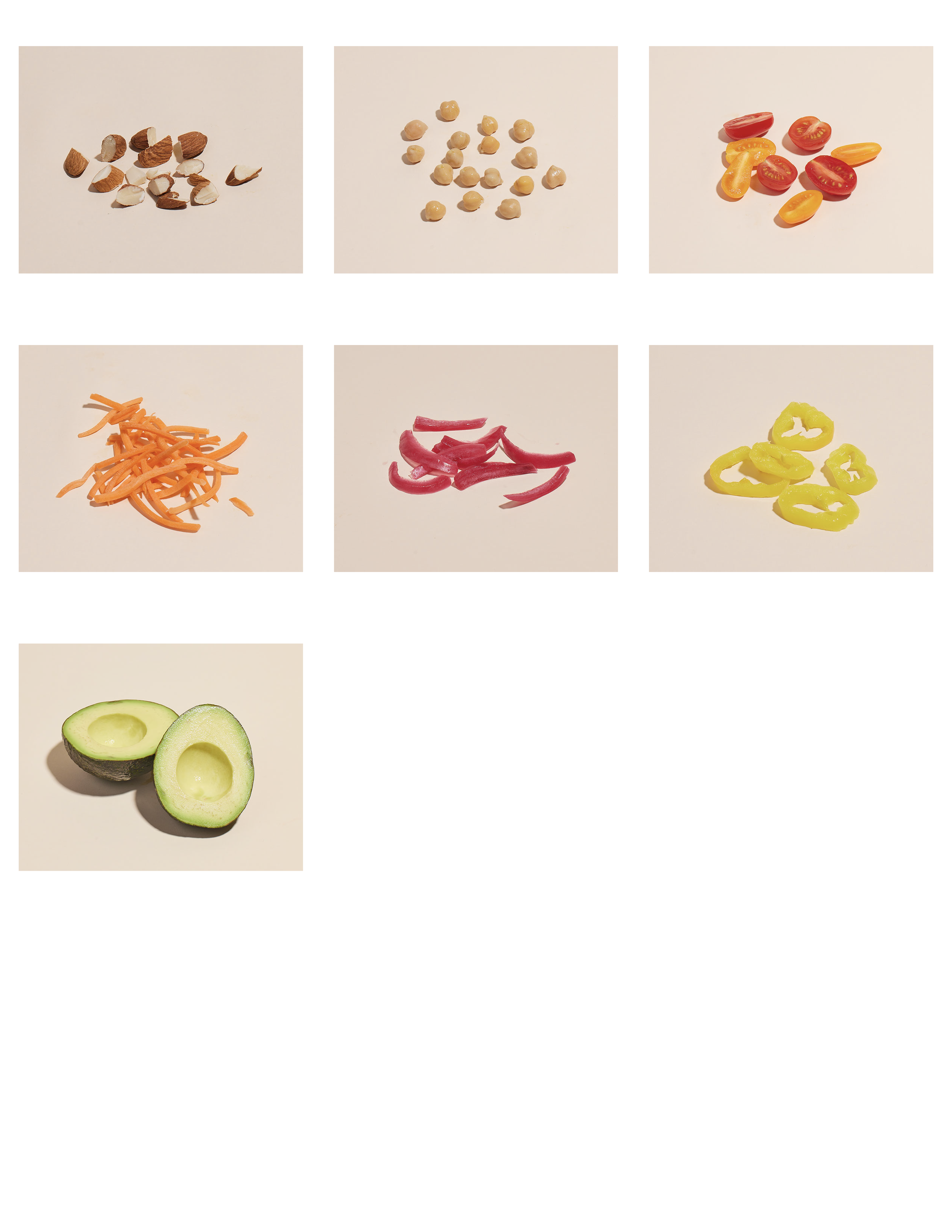Six different types of sliced or whole vegetables and fruits on a plain background, including almonds, chickpeas, cherry tomatoes, shredded carrots, sliced red onions, sliced yellow peppers, and a halved avocado.