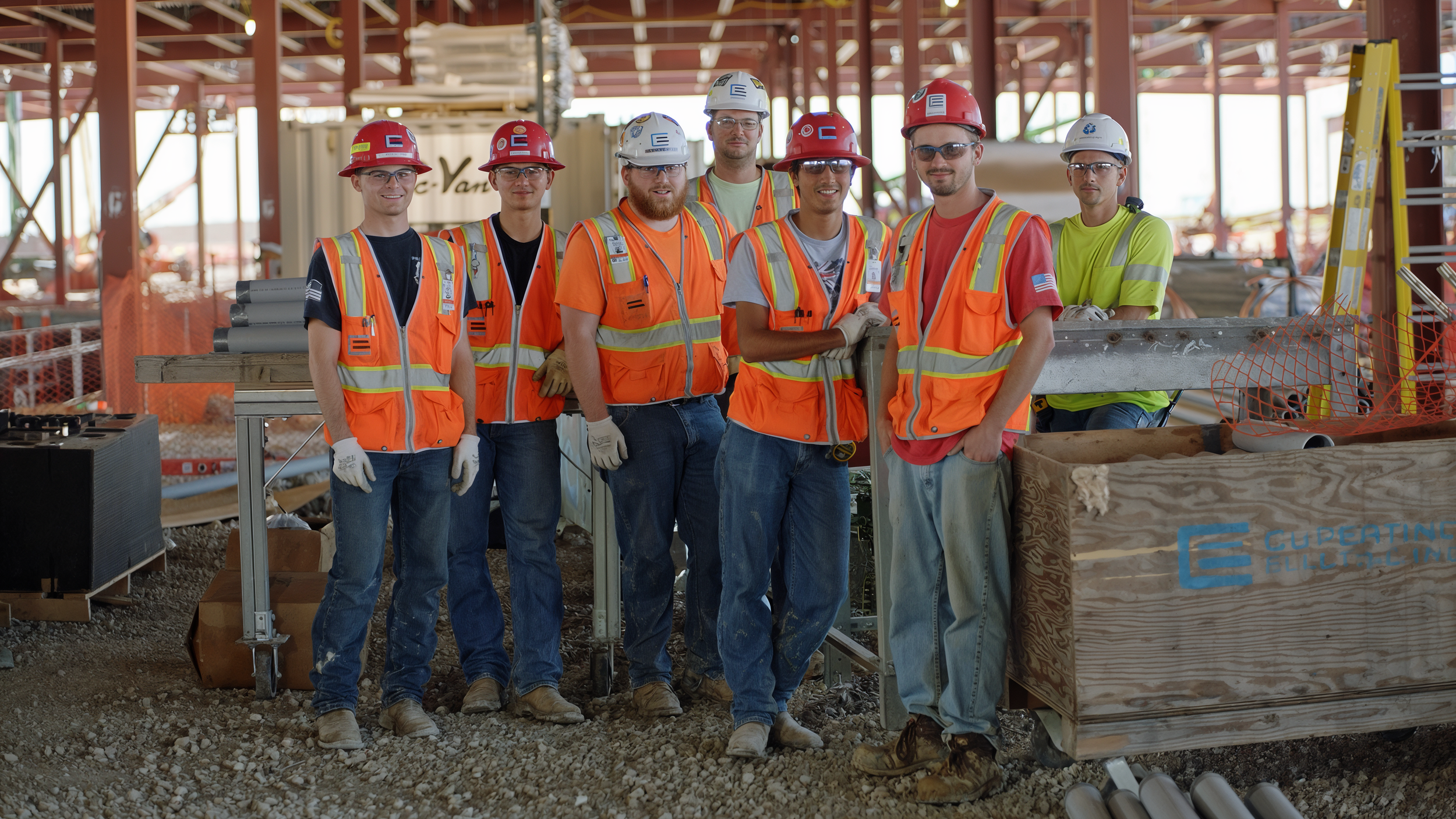 Group of construction workers wearing safety vests and helmets on a construction site