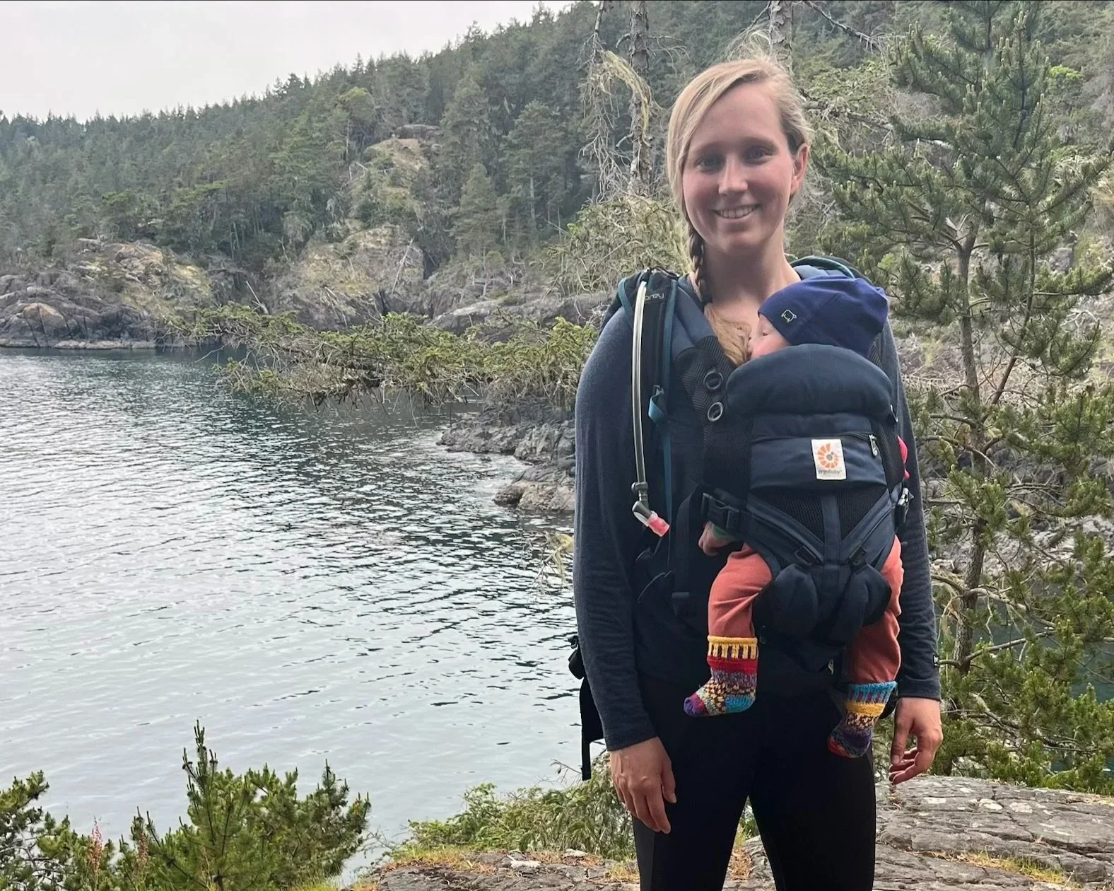 Anika carries her baby on a hike in Songhees territory.