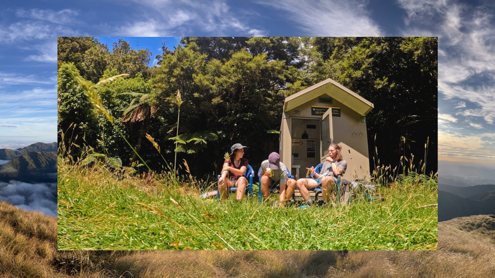 Three people sitting on blue chairs outdoors in front of a small electrical building, surrounded by grass and trees, under a partly cloudy sky.