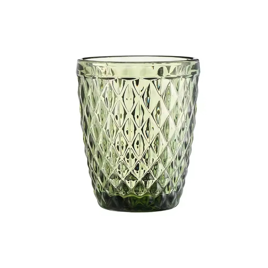 Green glass tumbler with a textured diamond pattern