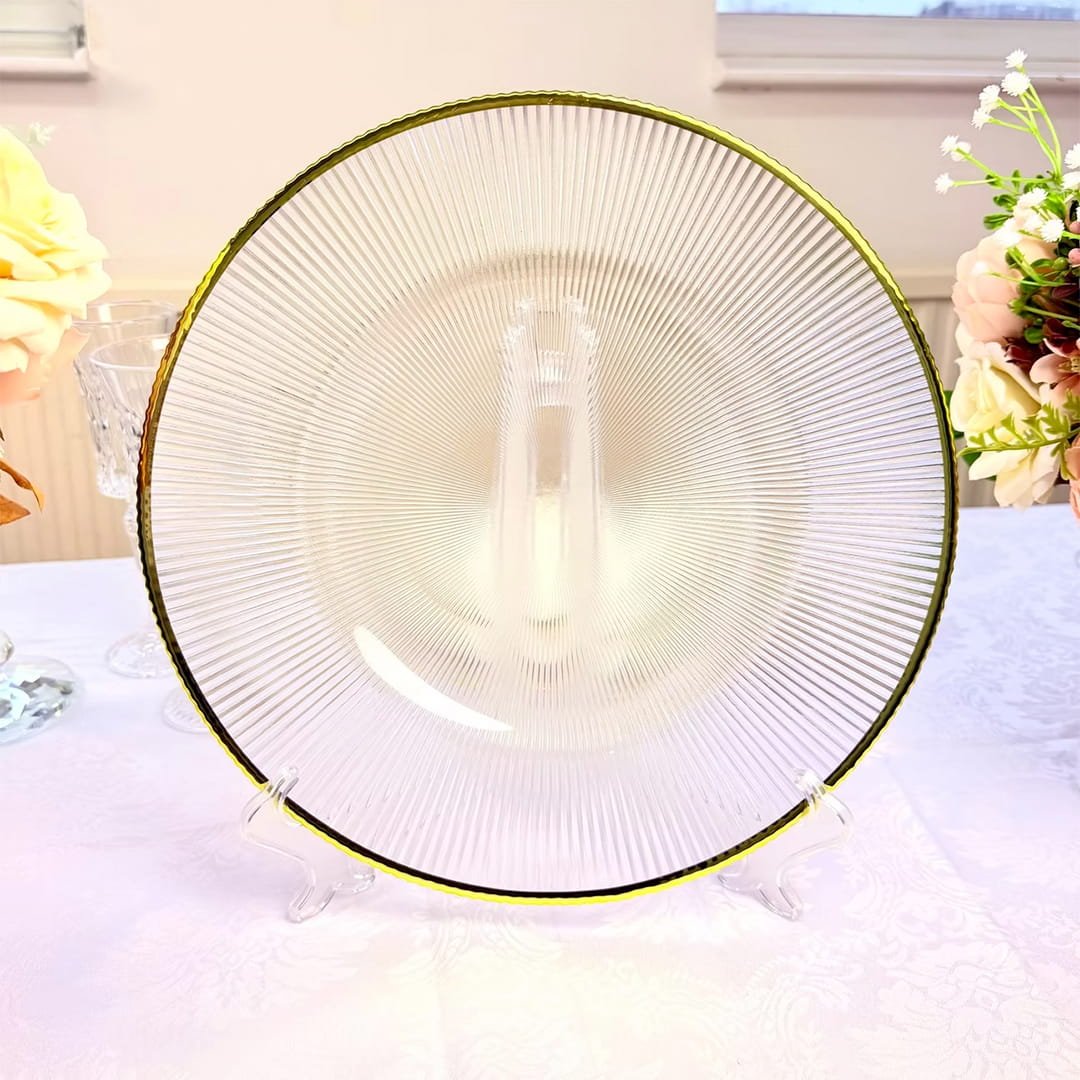 Clear ribbed charger plate with gold trim and textured pattern