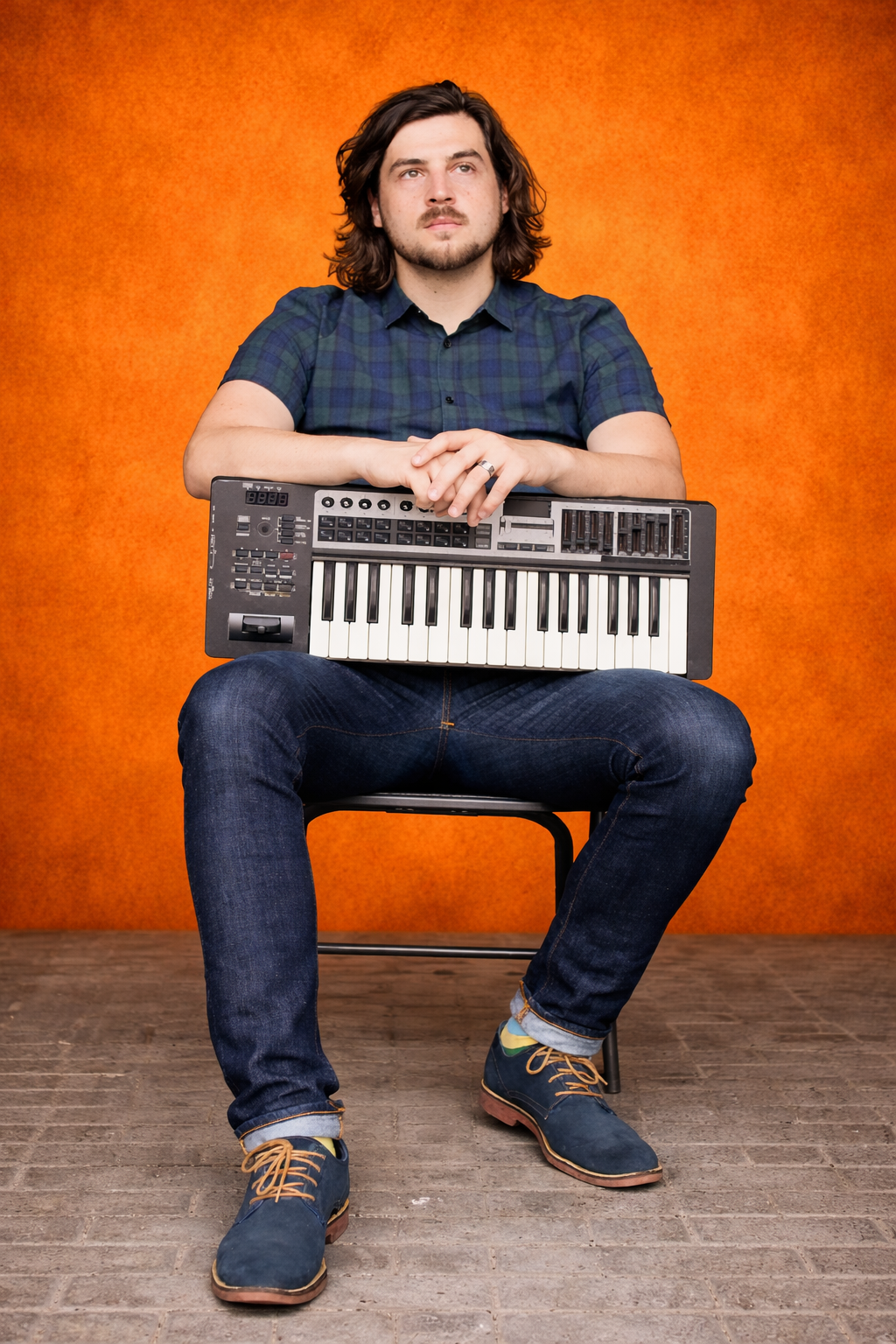 Composer Jesse Case with synthesizer on vibrant backdrop.pngComposer Jesse Case with synthesizer on vibrant backdrop