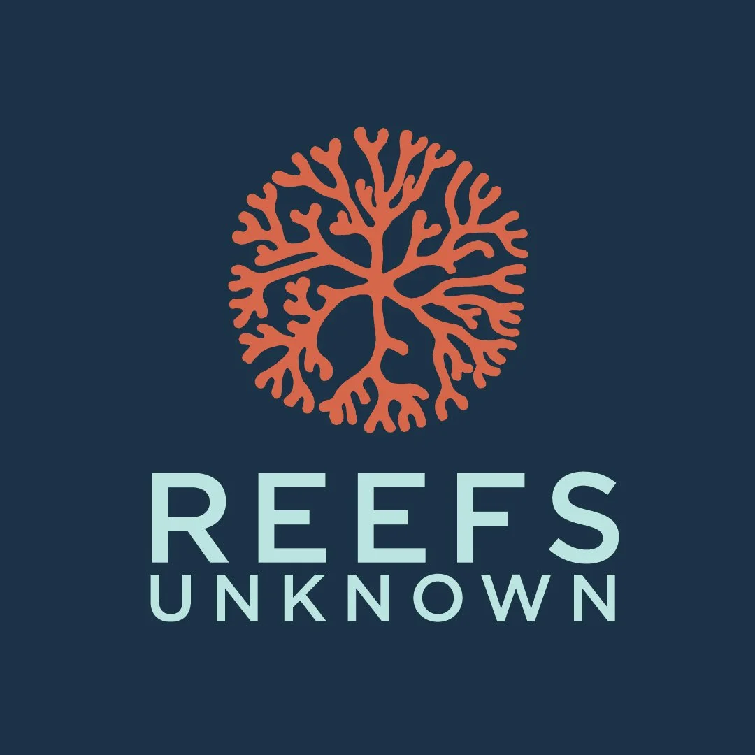 A logo with an orange coral-like symbol above the words "REEFS UNKNOWN" in light blue text on a dark blue background.