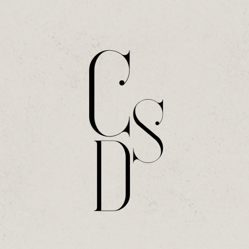 Stylized black letters C, S, and D arranged vertically on a light background.