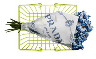 A shopping basket containing a bouquet of flowers wrapped in a Prada shopping bag with blue and white floral paper.