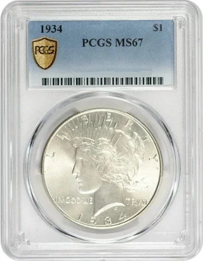 1934 silver dollar coin encapsulated in graded holder with PCGS MS67 label.
