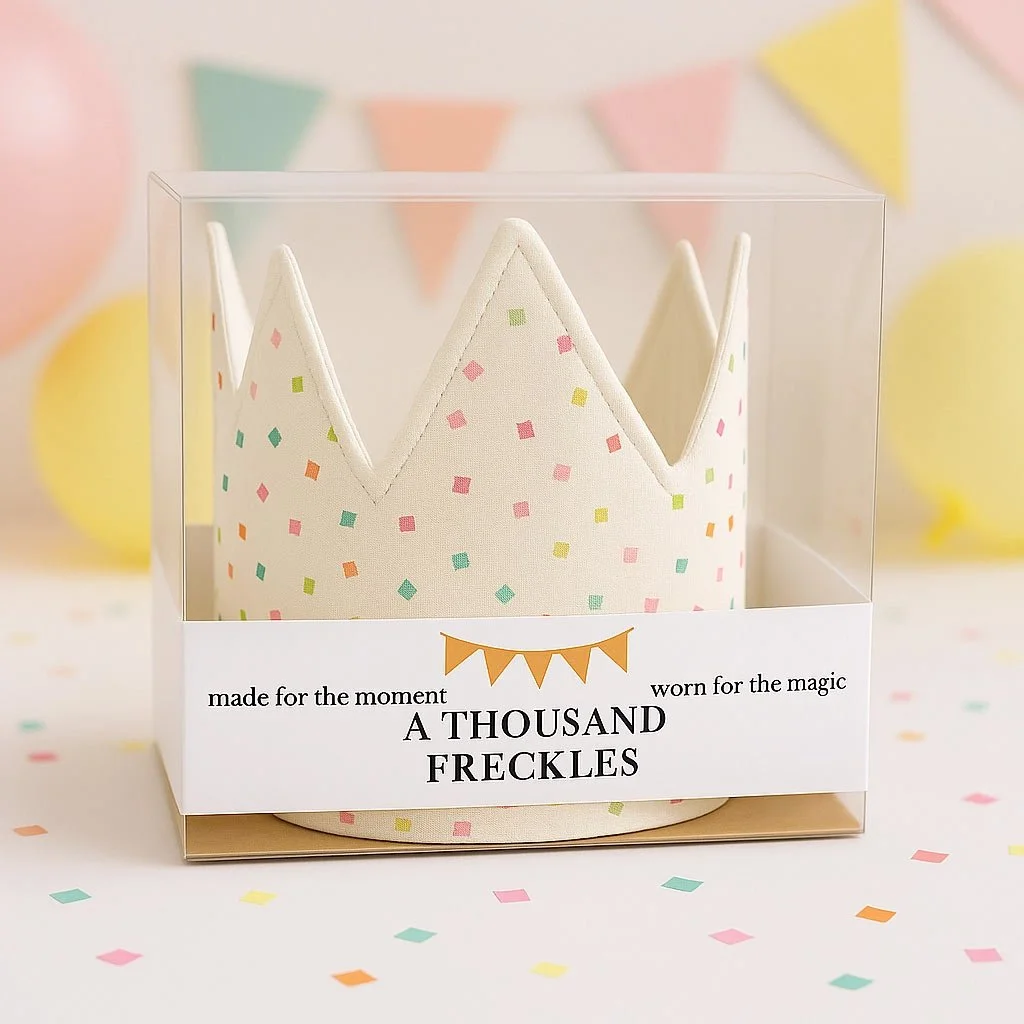 A boutique sprinkle-patterned birthday crown in designer packaging, perfect for high-end party supplies and gifts found at our Madrona studio.