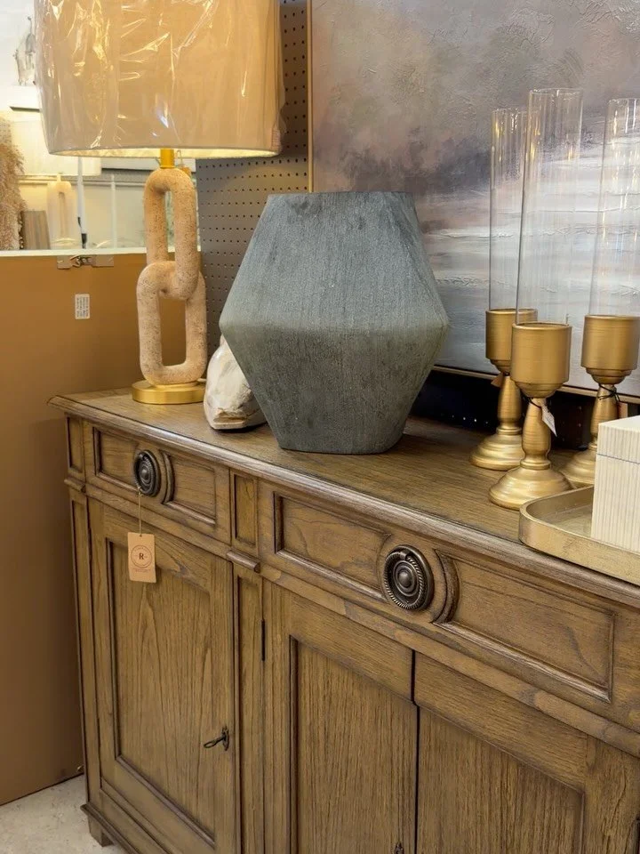 The little details are what make a space feel collected. 🤎 A moody landscape, sculptural lamps, and a warm wood cabinet with key handles set the scene, with a few more pieces to discover as you look around. Come see this setup at Riverside Franklin!