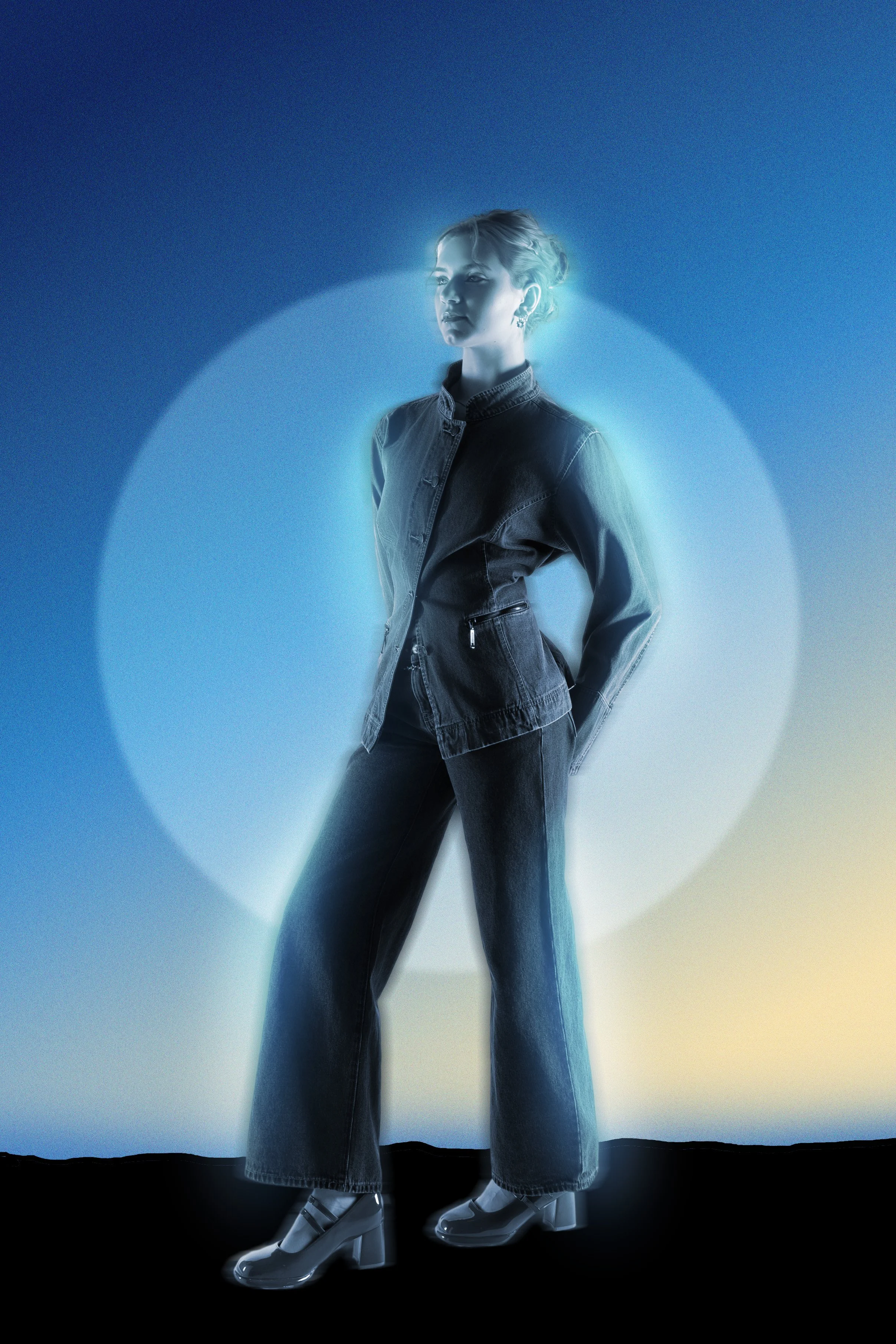A woman with short hair in a denim jacket and bell-bottom jeans, wearing shiny high heel boots, standing in front of a background with concentric circles of blue, gray, and light yellow, illuminated by a bluish glow.