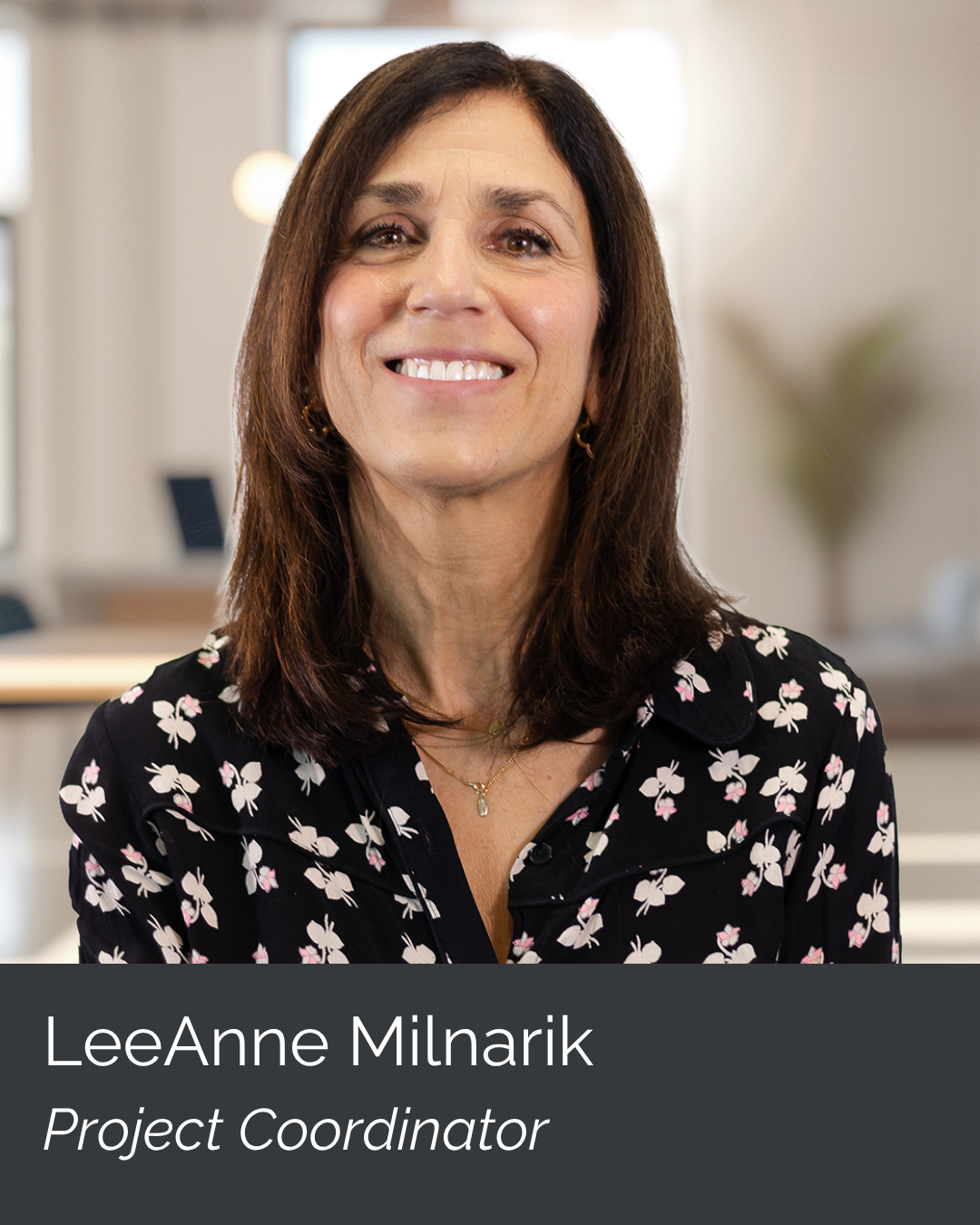 Photo of LeeAnne Miñarik, a project coordinator, smiling indoors with a blurred background.
