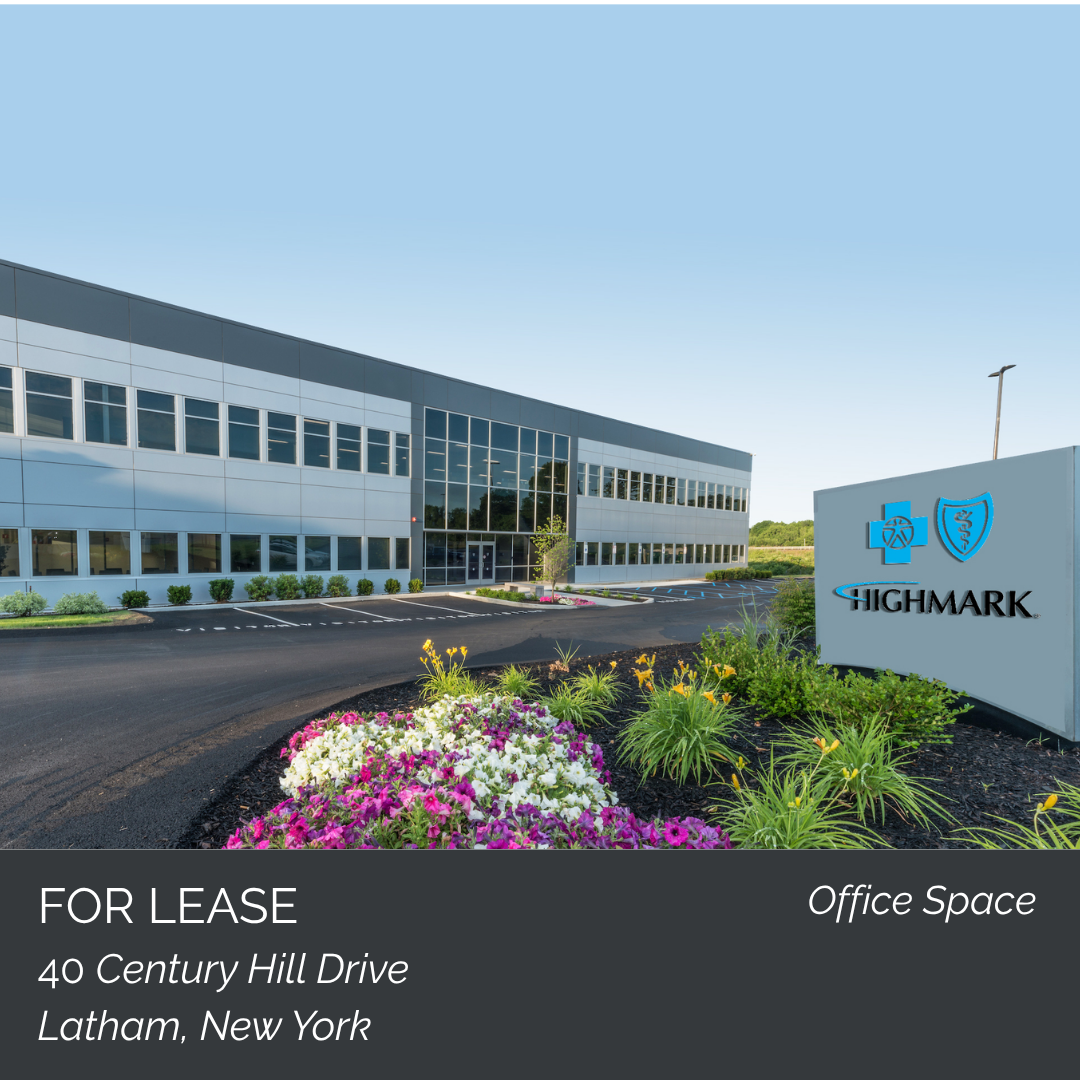 An office building with a parking lot and a landscaped garden in front. A sign reads 'Highmark' with medical and shield icons. The property is located at 40 Century Hill Drive, Latham, New York, for lease.