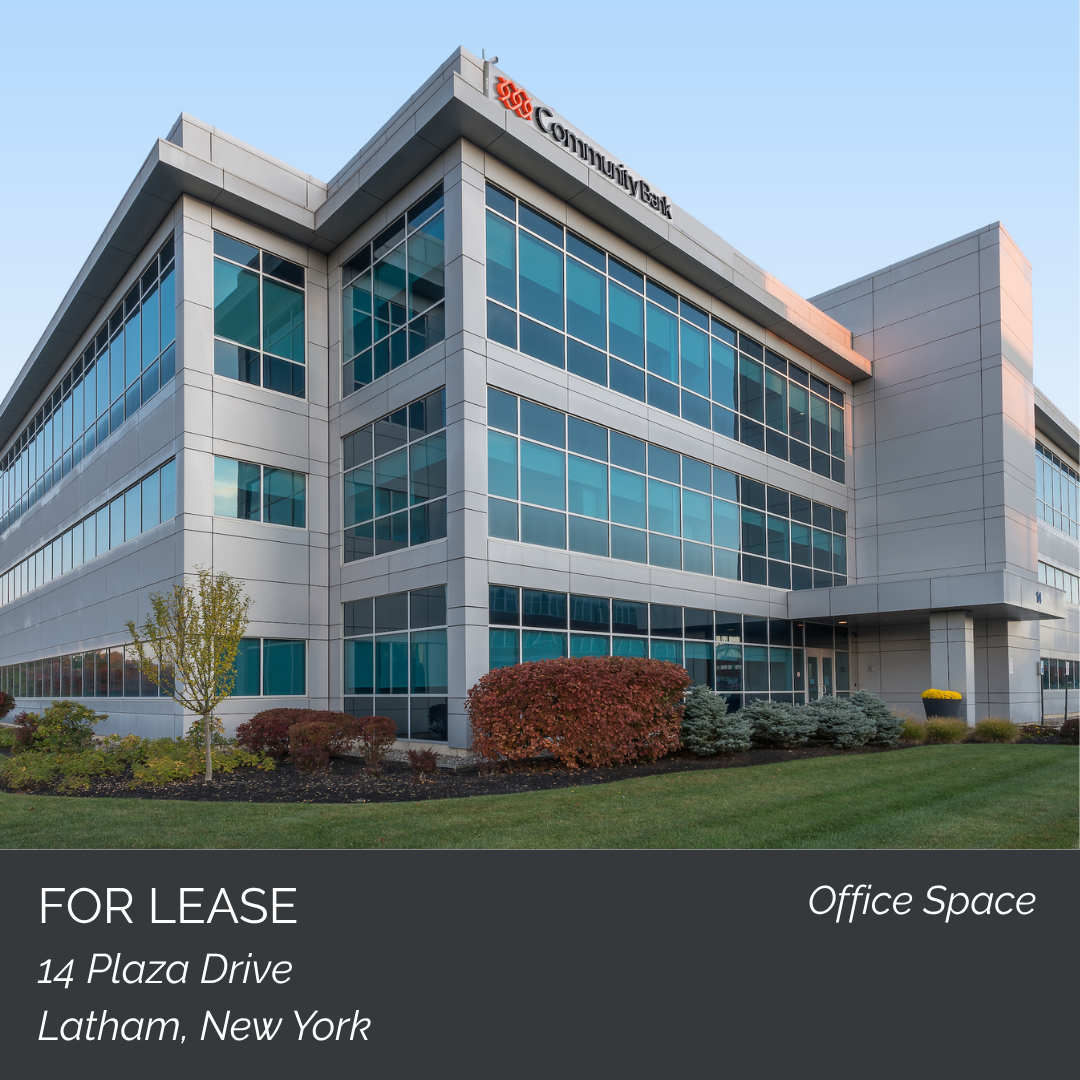 Modern office building with glass windows and landscaping, advertising office space for lease at 14 Plaza Drive, Latham, New York.