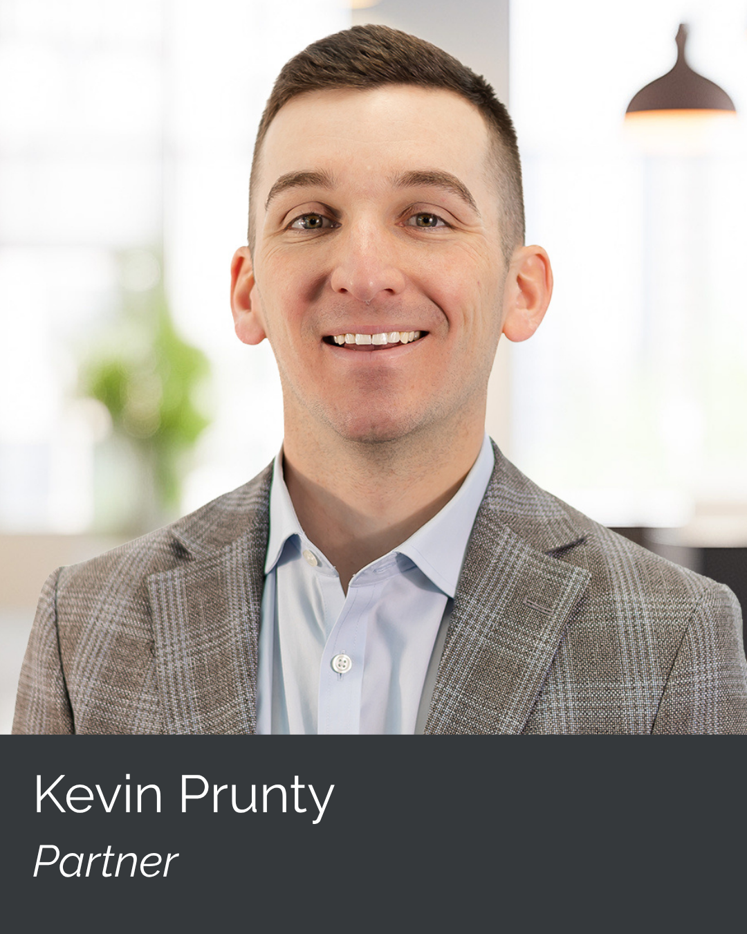 Professional headshot of Kevin Prunty, a partner, smiling in a corporate setting.