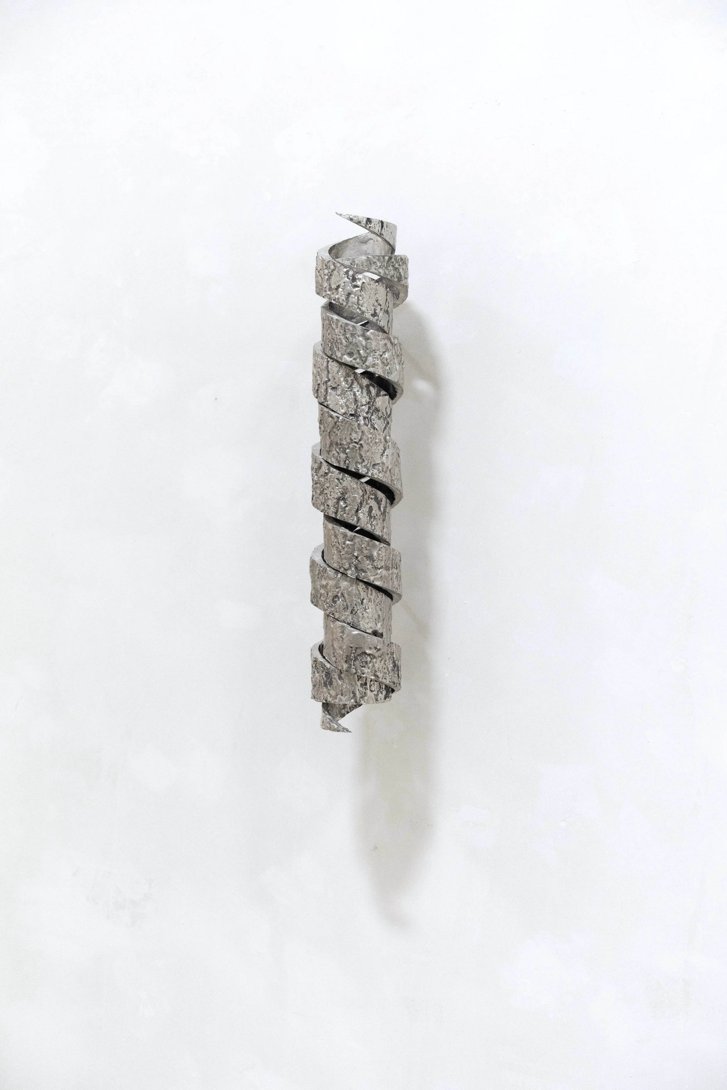 Untitled (Embrace), 40cm x 8cm x 7cm,  cast tin, steel, 2025