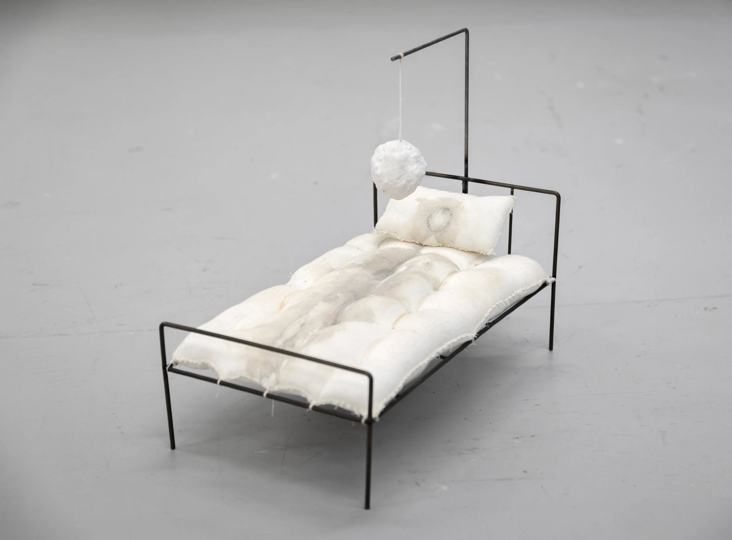 How many nights have I drowned?, 38cm x 22cm x 34cm, steel dollsbed, handsewn stained pillows and plaster, 2024