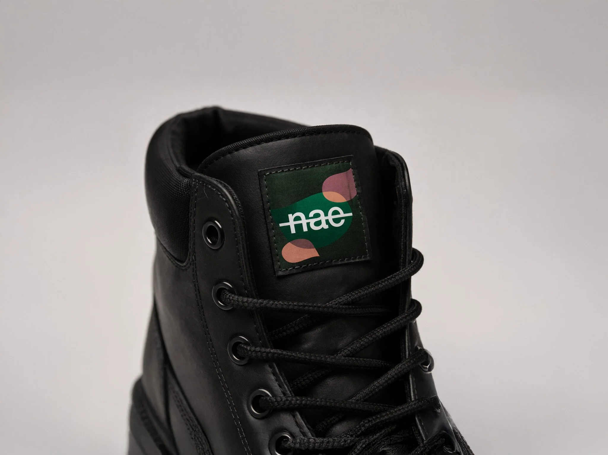 Black boot with modern logo details.jpg