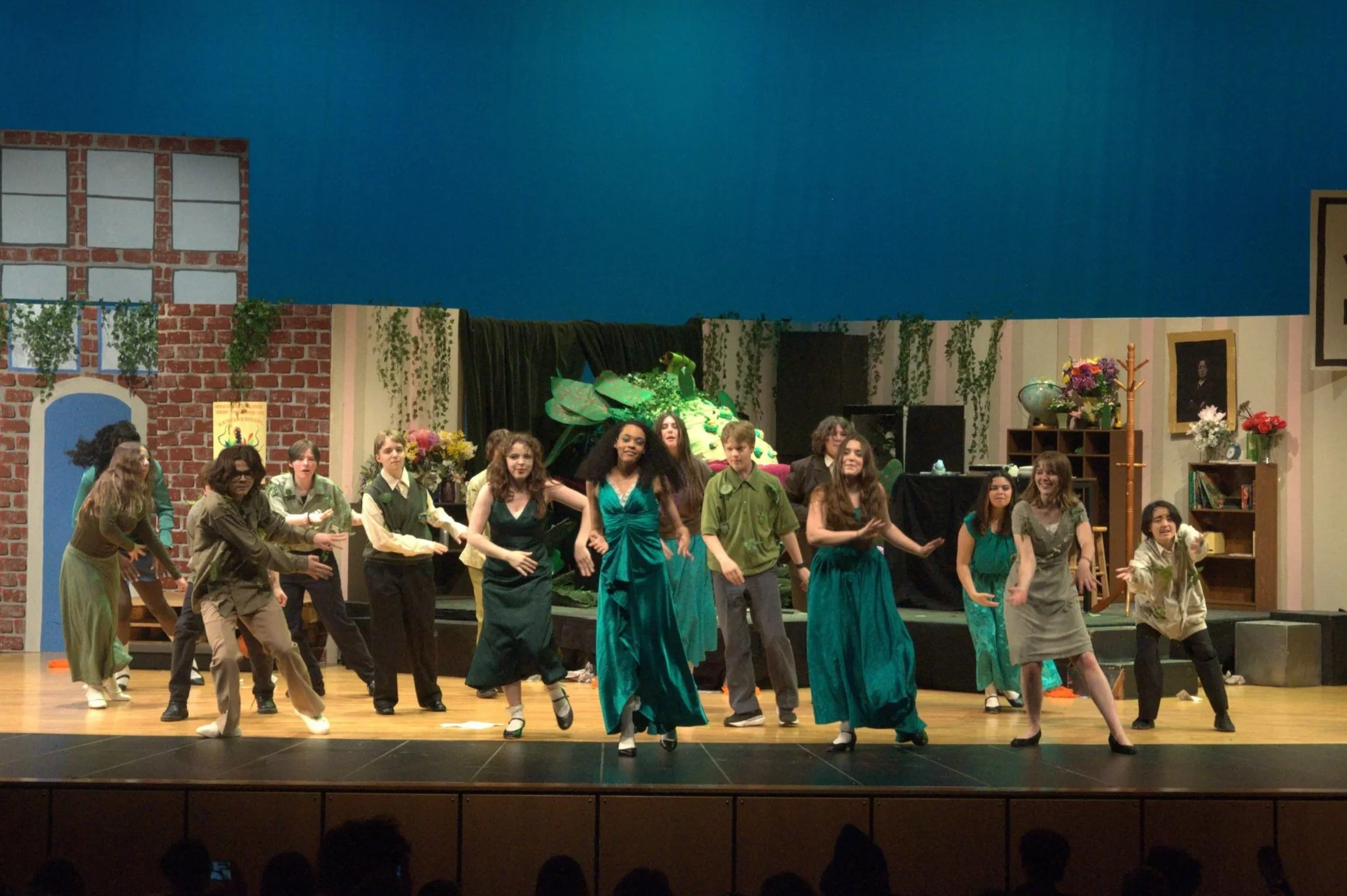 Chief Sealth High School drama students perform the musical, Little Shop of Horrors on stage with a choreographed dance.
