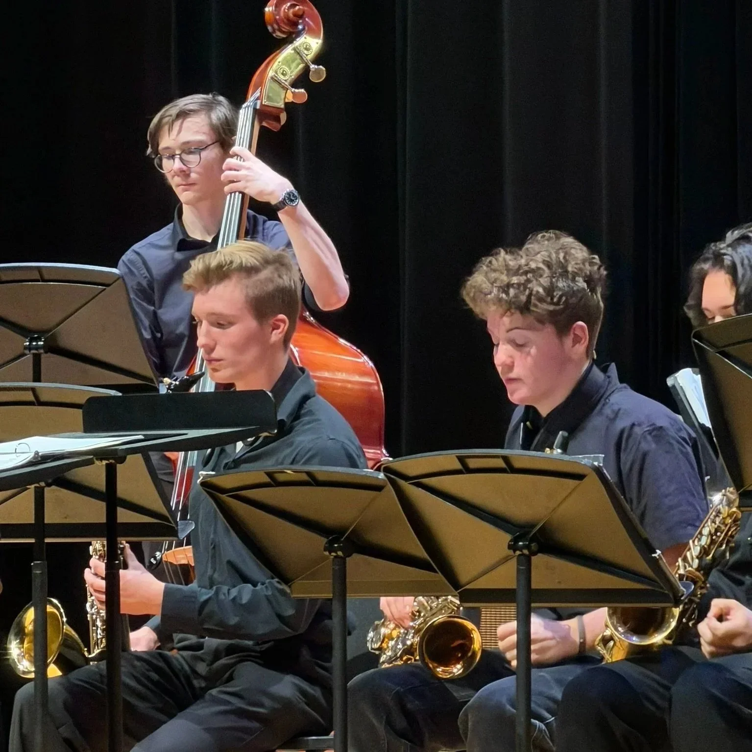 Four musicians performing jazz music on stage