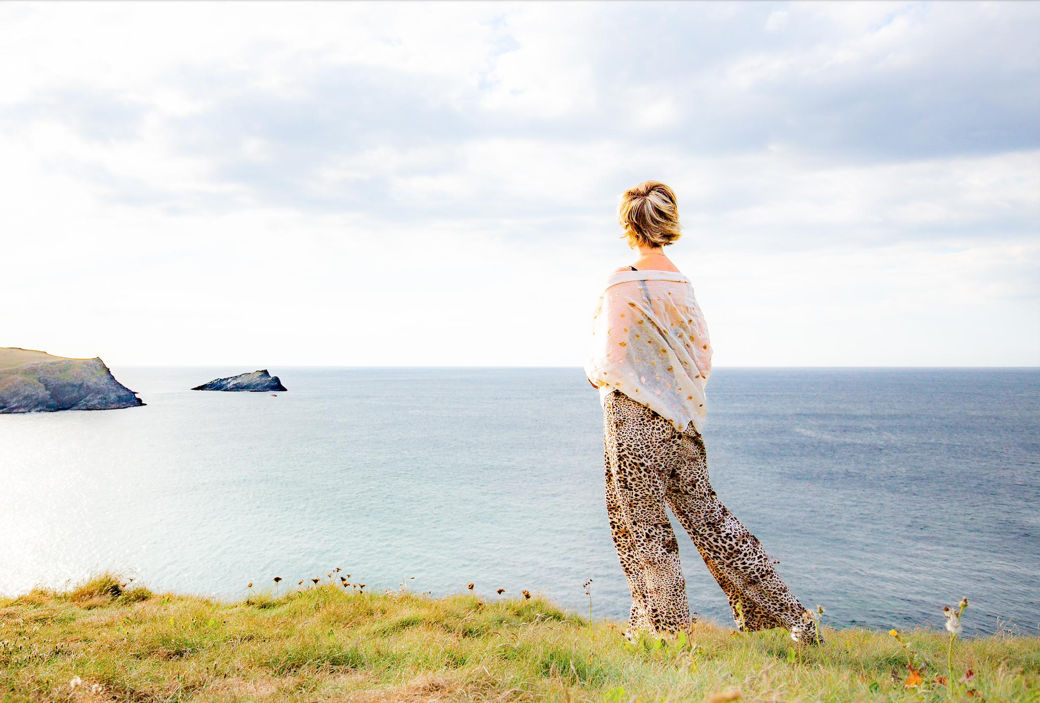 Julia Poole artist walking on the cliff path gazing out to a blue sea