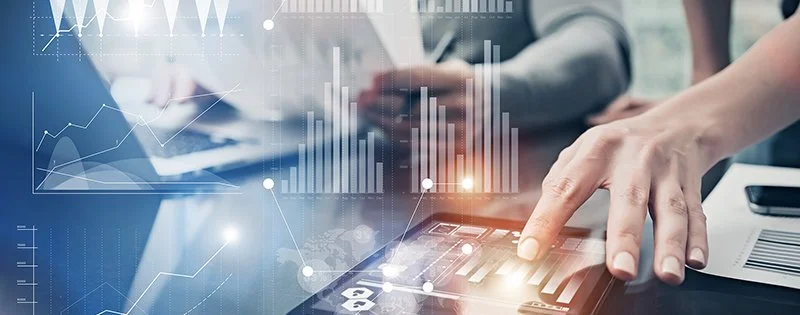 Person using a tablet with financial and data analytics graphics overlayed.