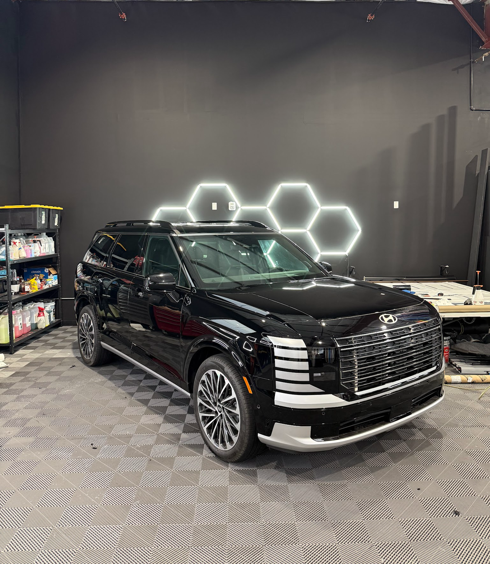 Black Hyundai Palisade on its factory machined silver wheels before powder coating at Zeal Restyling