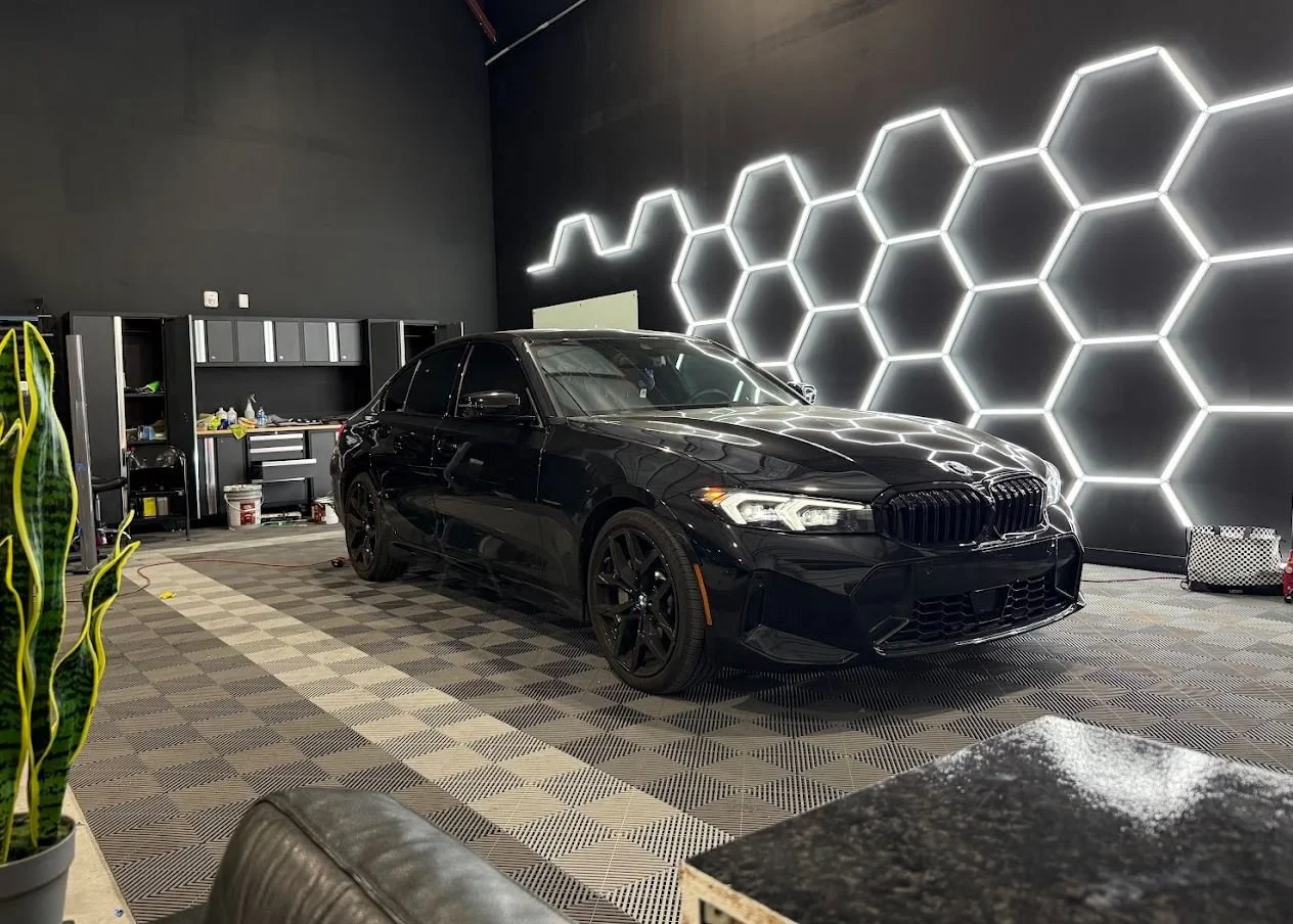 Black BMW in the Zeal Restyling tint bay after a ceramic window tint install