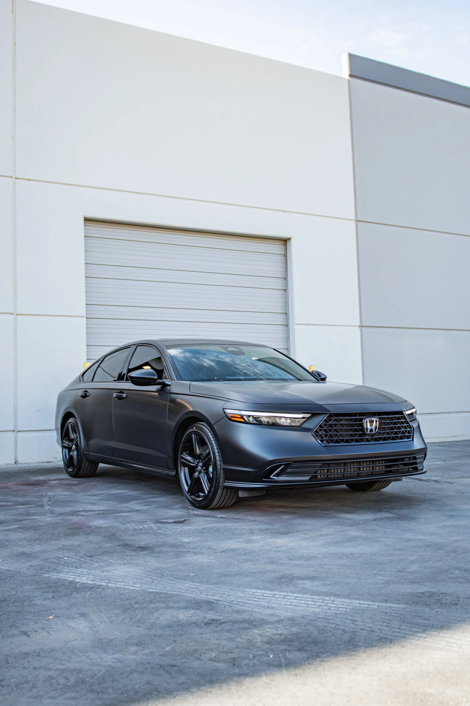 Satin black vinyl wrapped Honda sedan