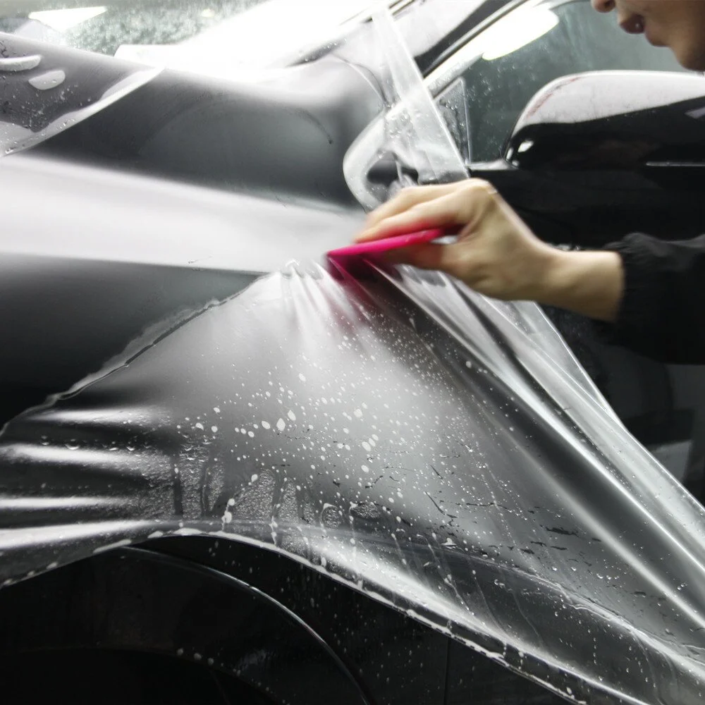 Technician installing 10 year self healing paint protection film at Zeal Restyling in Bluffdale, Utah