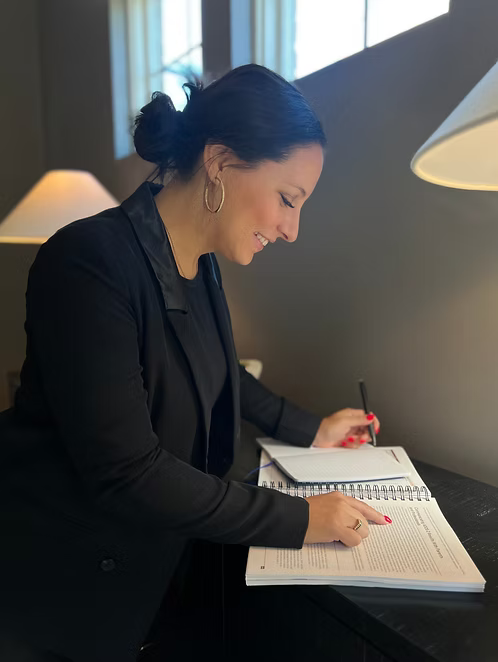 Founder Allison Charette working in notebook