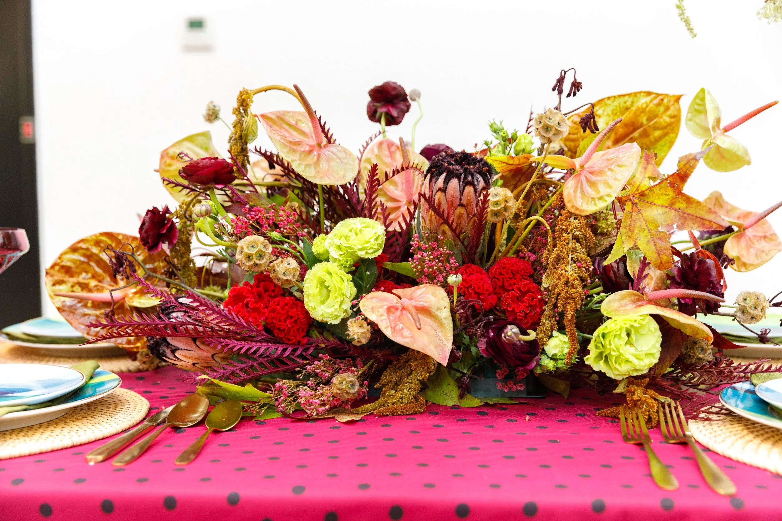 large table floral arrangement. Textured fall floral arrangement. Anthurium, scabiosa, protea, ranunculus, celosia, kangeroo paw, sumac.