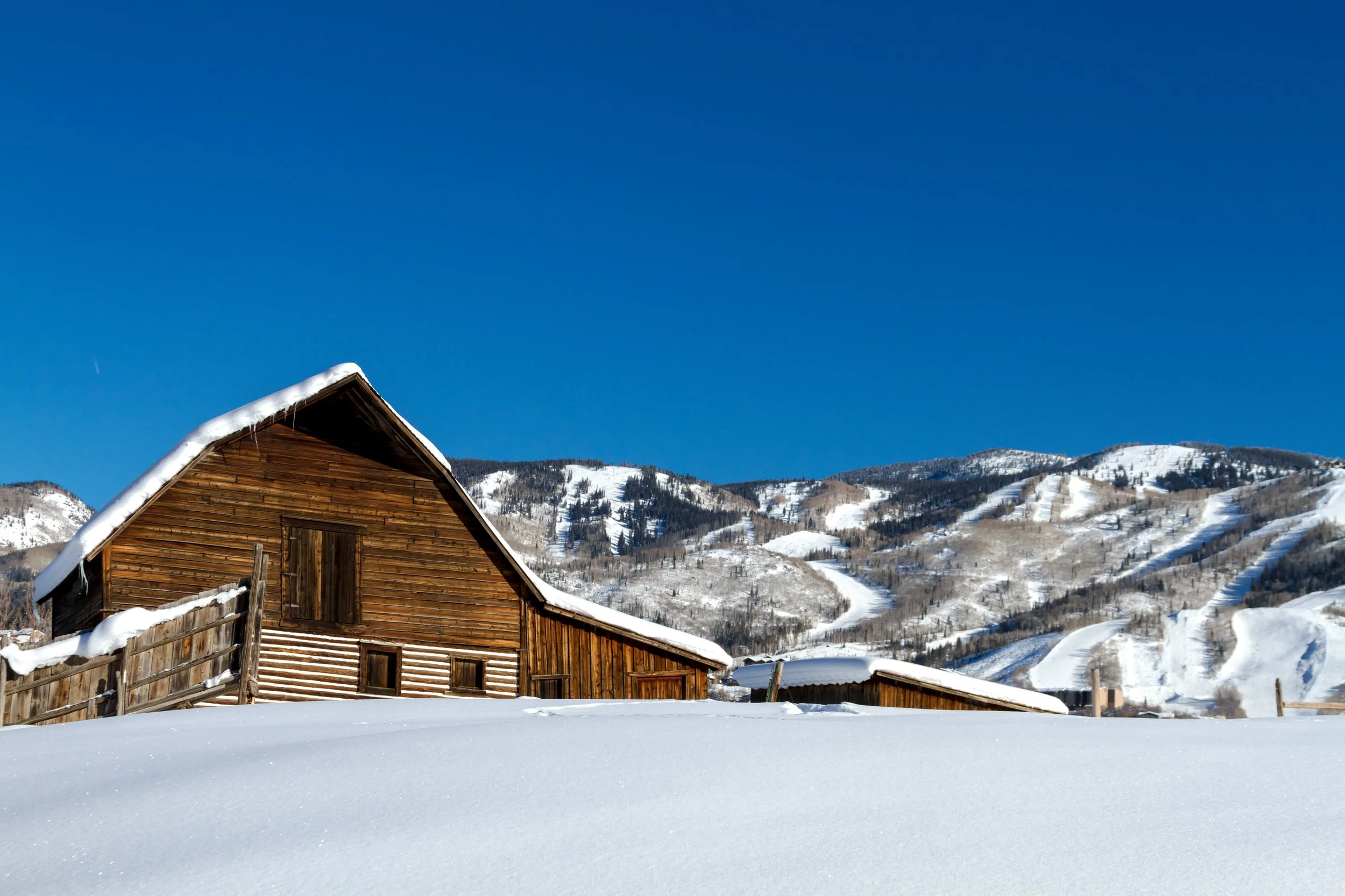 The iconic Steamboat "More" Barn with mountains visible in the background