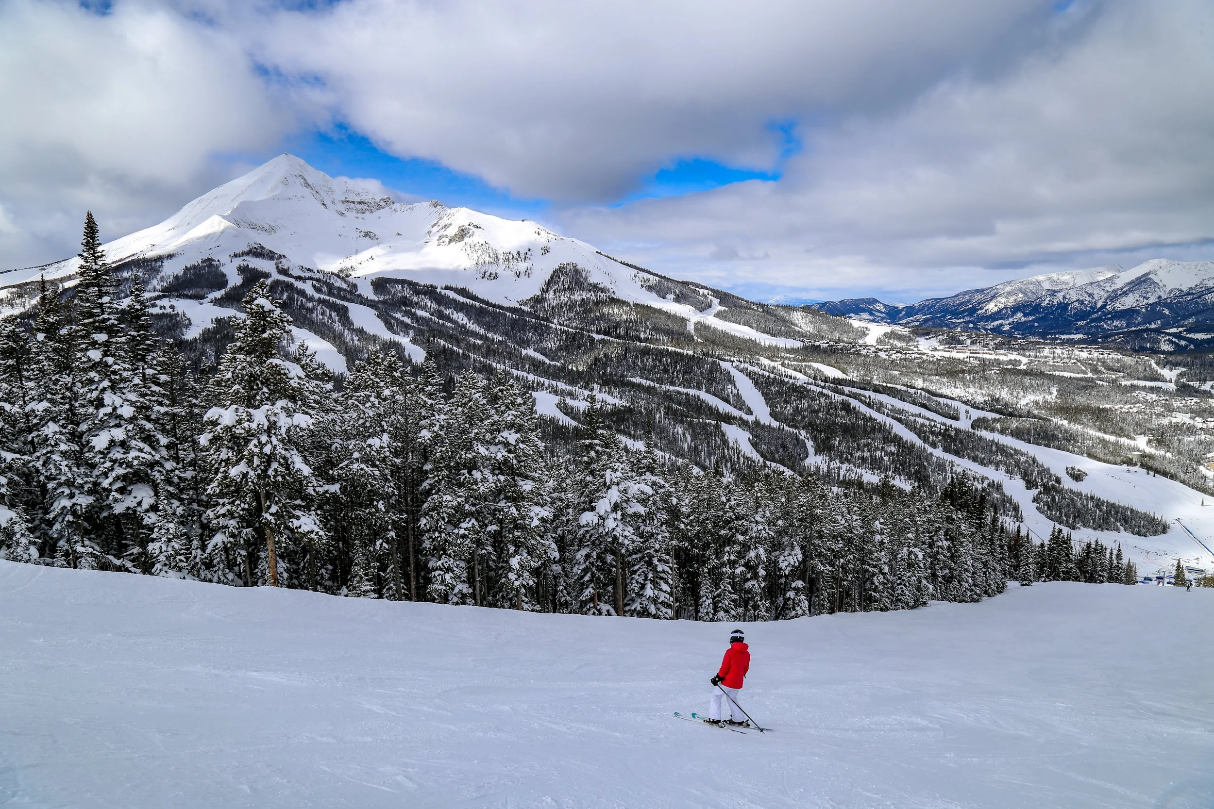 A skier looking at Lone Peak in Big Sky, Montana
