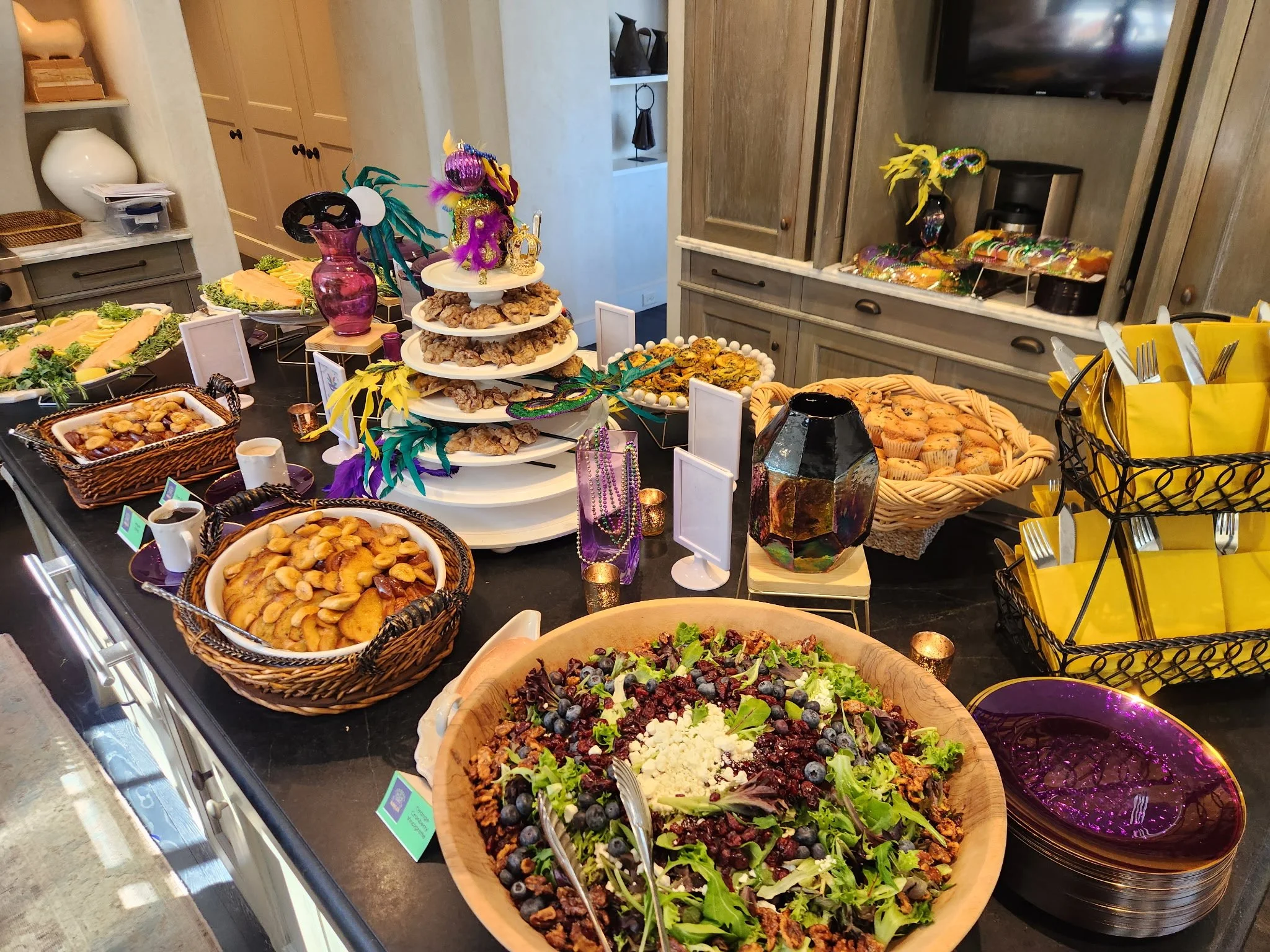 A variety of colorful salads, desserts, and finger foods arranged on a buffet table for a celebration or party.