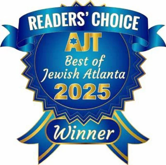 A blue award badge with gold accents and a ribbon at the bottom. Text reads: "Readers' Choice AJC Best of Jewish Atlanta 2025 Winner."