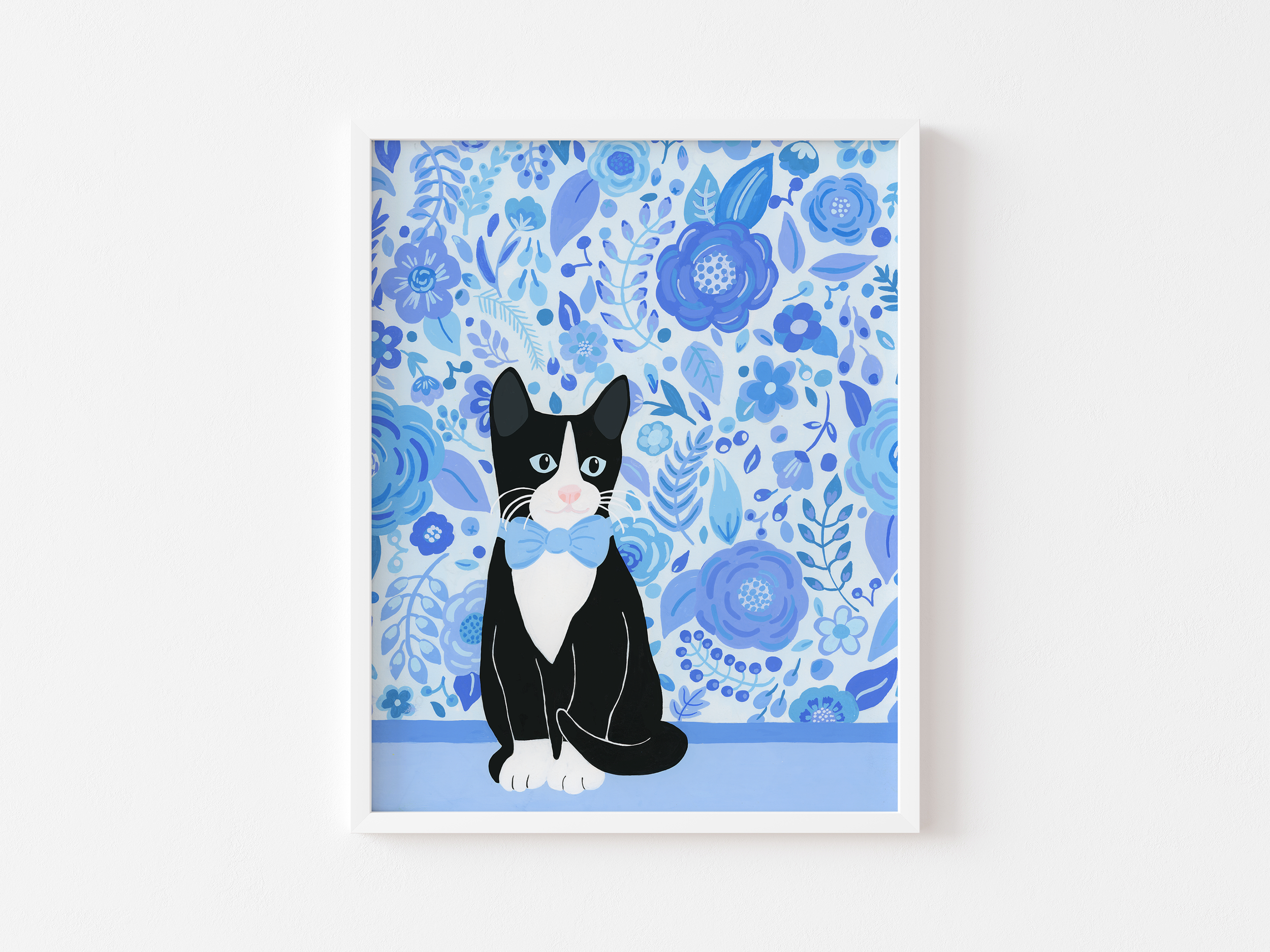 Art print of a tuxedo cat in a white frame