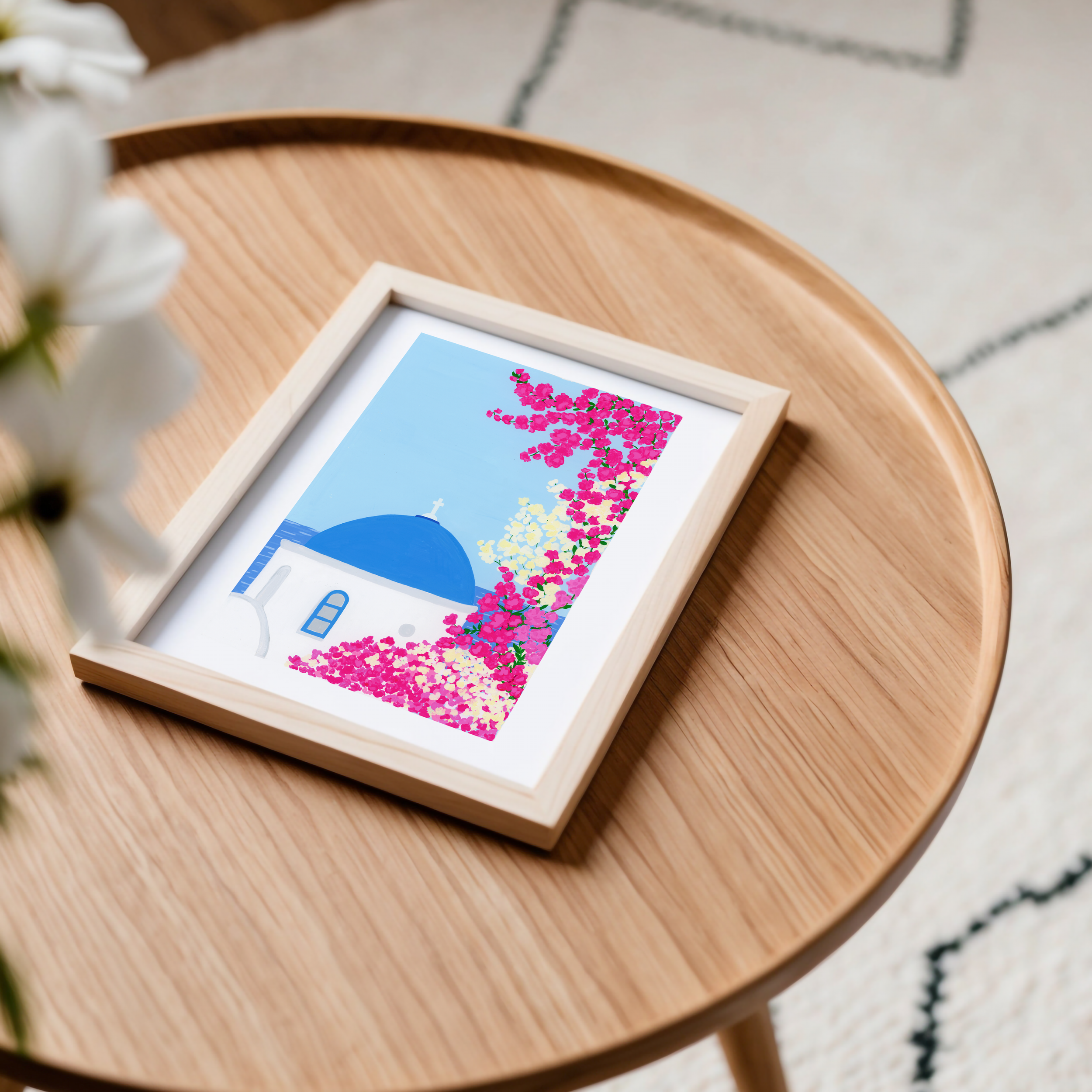 Art print of a Greek island framed on a table