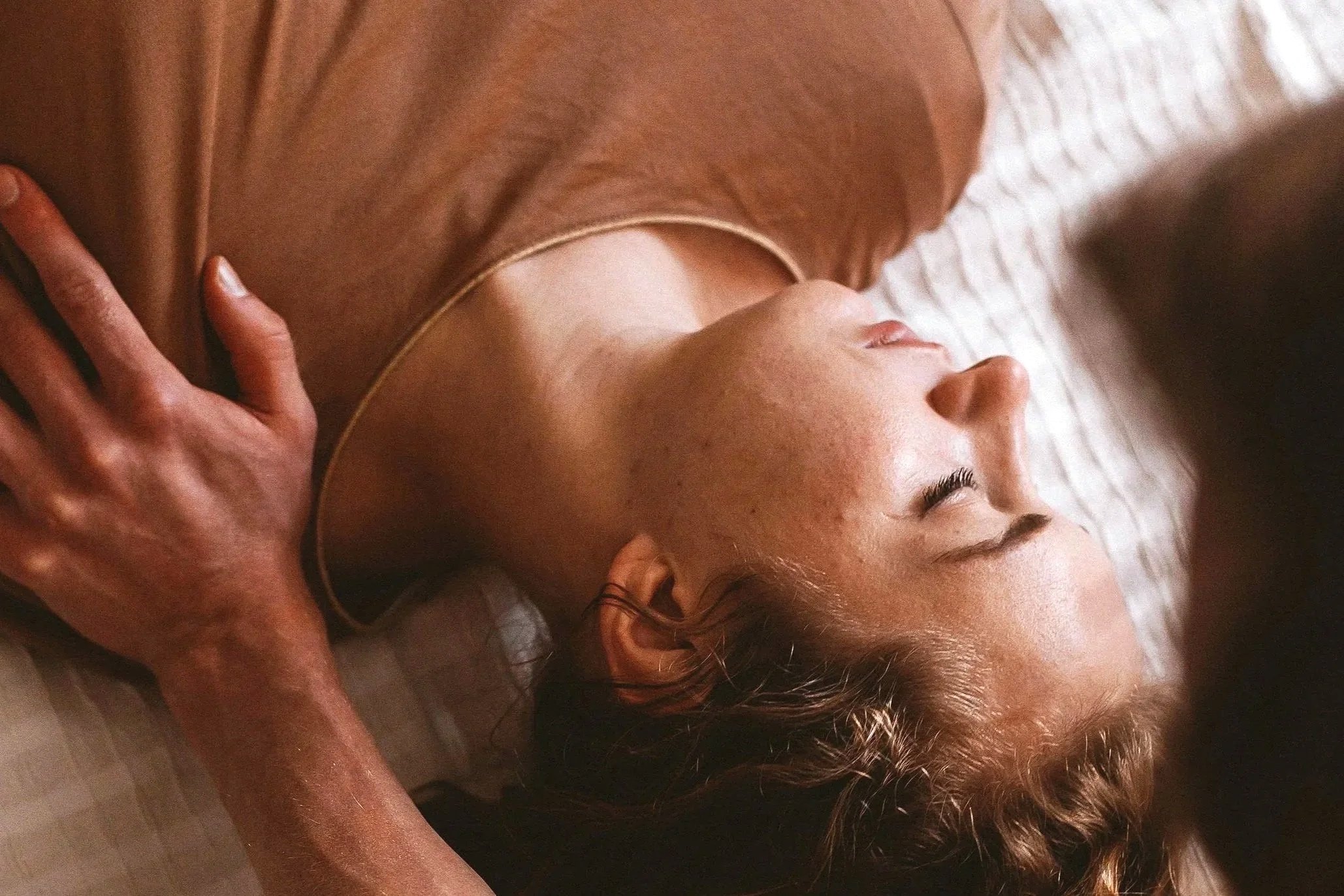 Woman in a relaxed state receiving Thai massage, symbolizing the beginning of a healing journey
